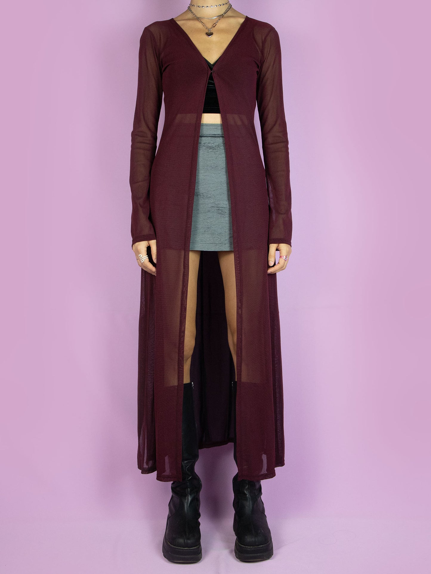 The Y2K Maroon Mesh Duster Jacket is a vintage 2000s cyber festival rave party style burgundy semi-sheer maxi long coat with bell sleeves and a front hook closure.