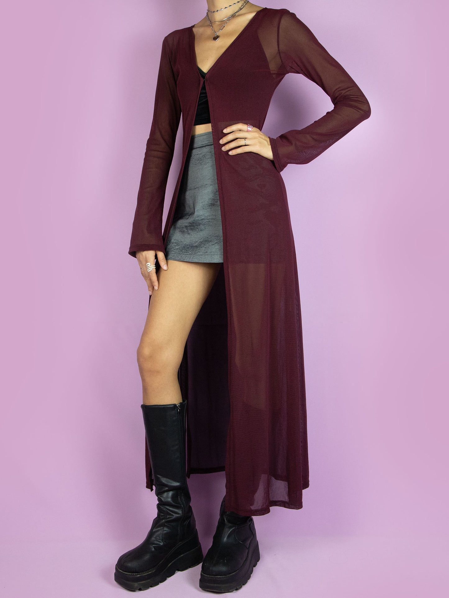 The Y2K Maroon Mesh Duster Jacket is a vintage 2000s cyber festival rave party style burgundy semi-sheer maxi long coat with bell sleeves and a front hook closure.