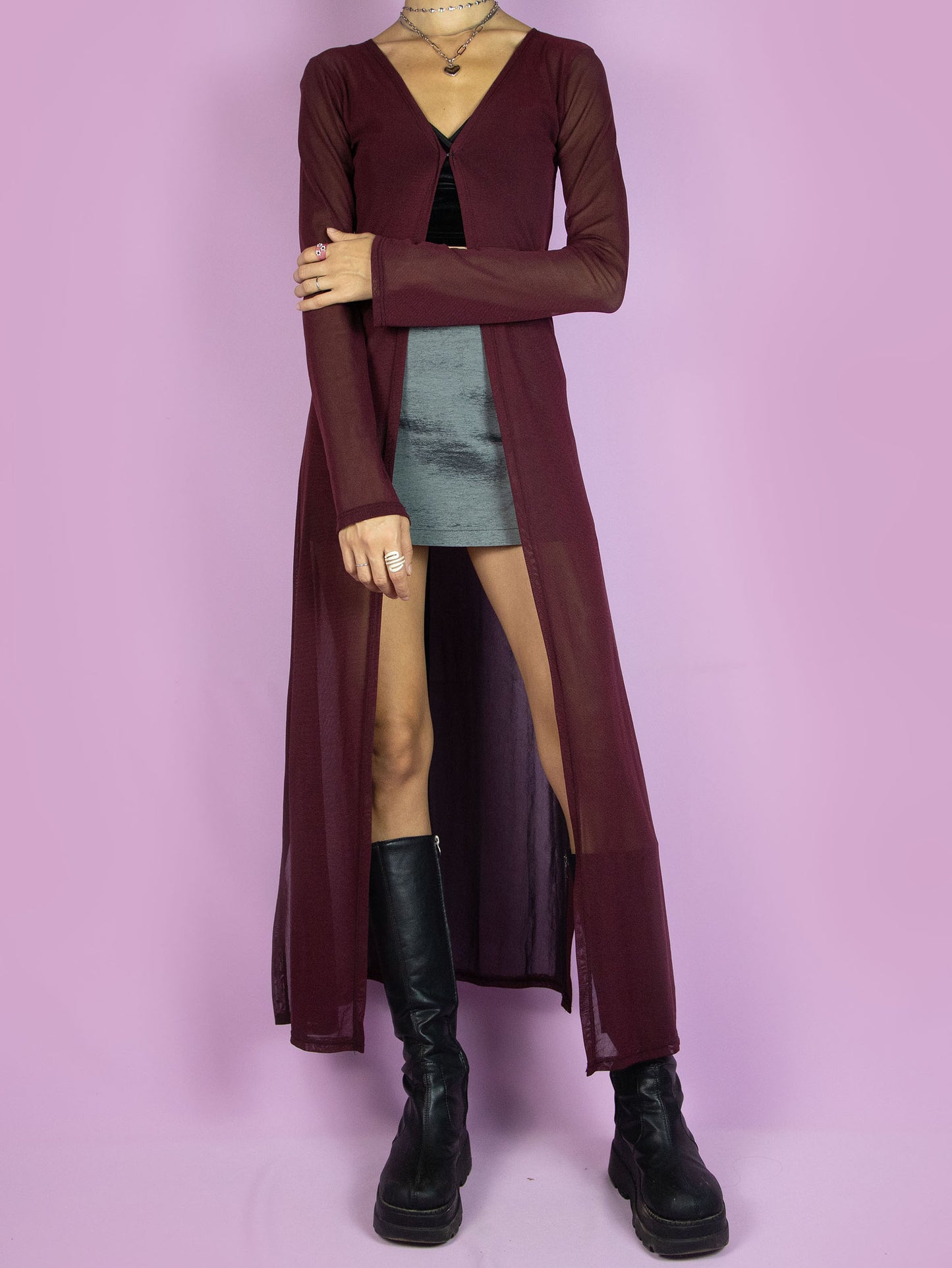 The Y2K Maroon Mesh Duster Jacket is a vintage 2000s cyber festival rave party style burgundy semi-sheer maxi long coat with bell sleeves and a front hook closure.