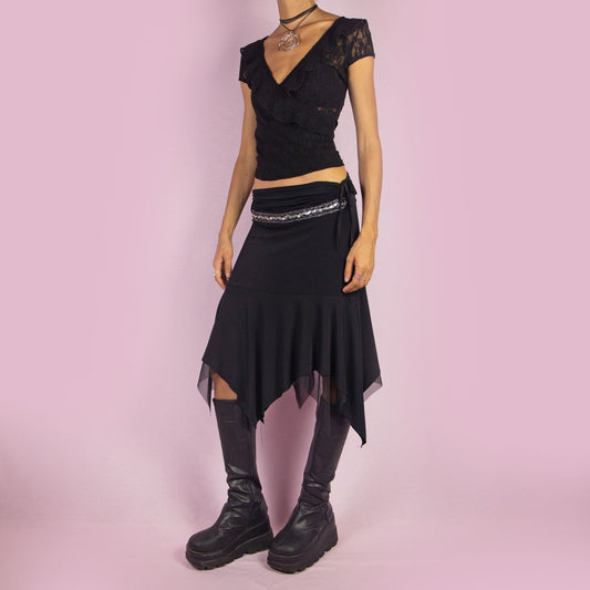 The Y2K Black Layered Asymmetric Skirt is a vintage 2000s piece featuring an avant-garde design. It has intricate bead detailing on the waist and adjustable ruched side ties. The skirt includes mesh sheer layers and a handkerchief-style asymmetric hemline, making it perfect for a bold night out look.