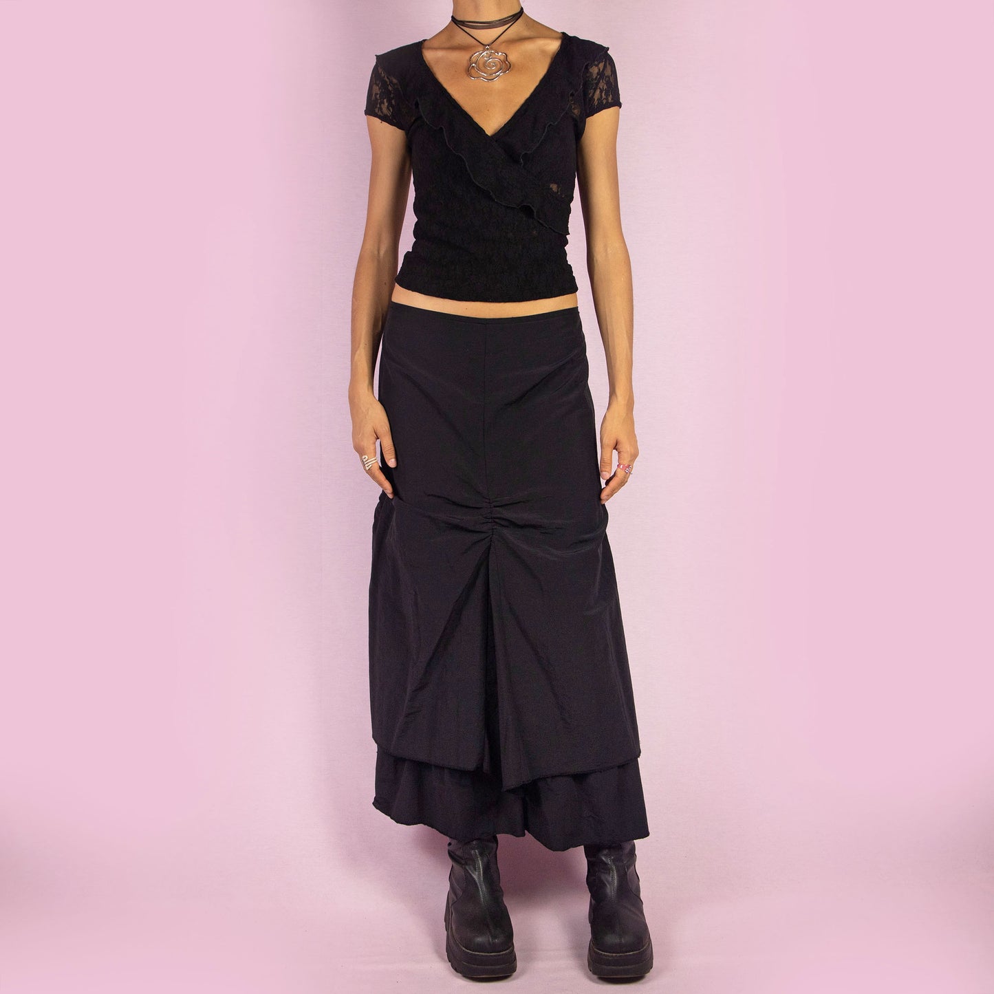 The Y2K Black Layered Midi Skirt is a vintage 2000s piece that features a unique, layered design with ruched details along the front. It includes a back zipper closure and a high-waisted fit. Perfect for both casual and night-out outfits.
