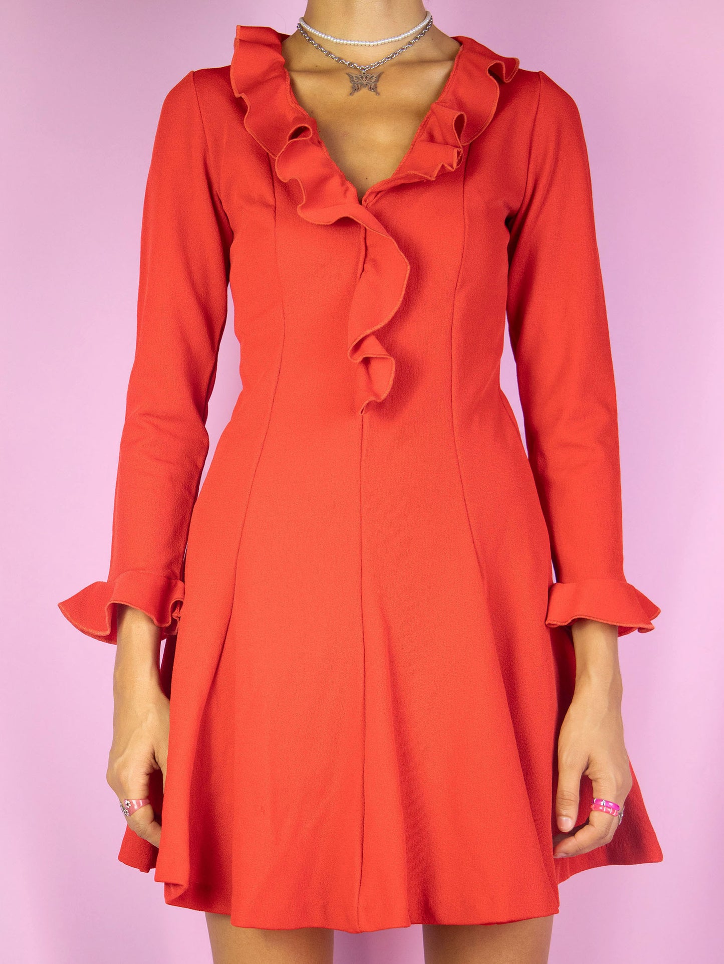 The Vintage 90s Red Ruffle Mini Dress is a red long sleeve flare dress with ruffle details. Romantic 1990s party mini dress.