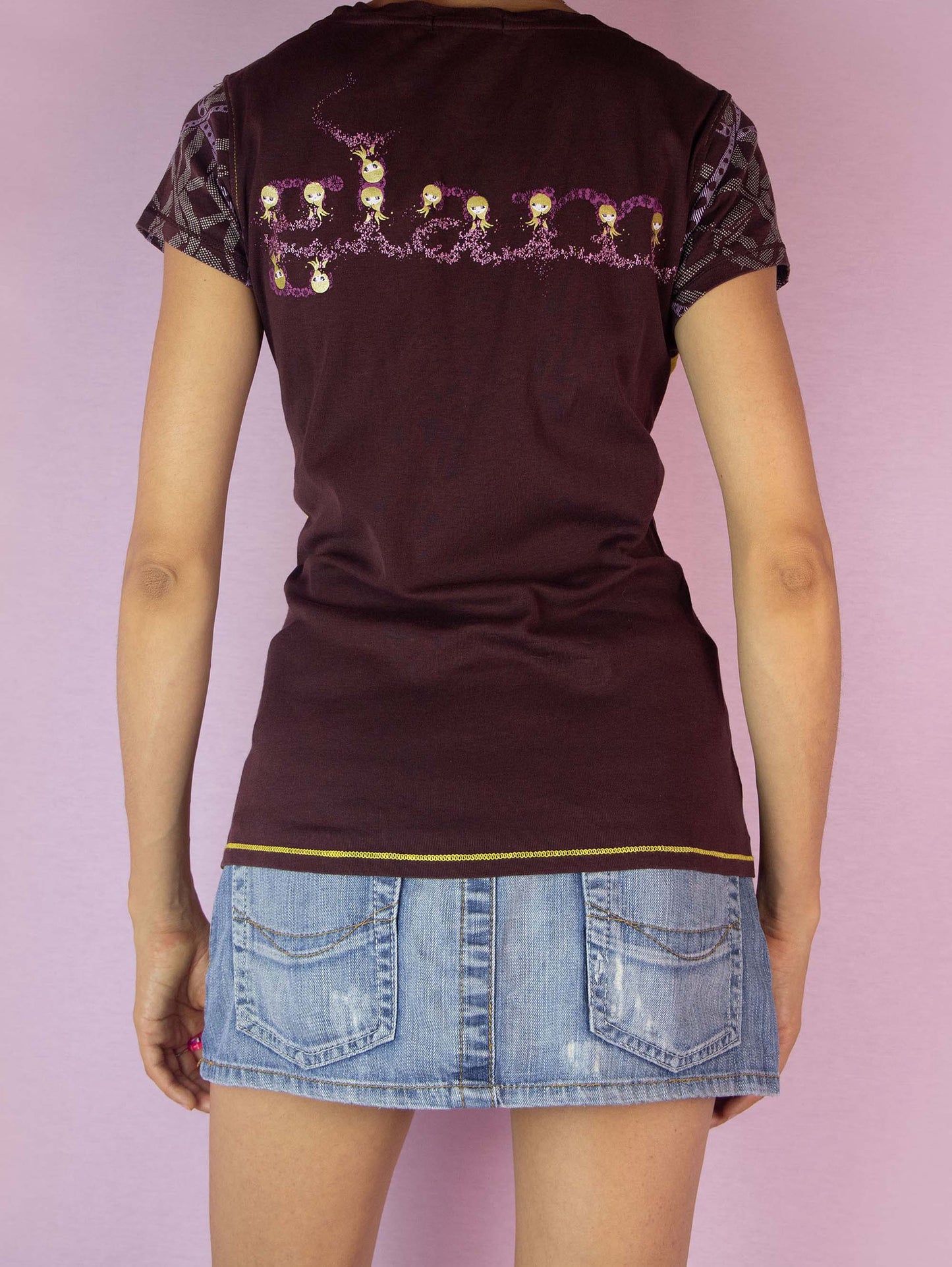 The Y2K Custo Barcelona Graphic Top is a vintage 2000s t-shirt featuring a vibrant multicolored graphic on the front and intricate print details on the short sleeves. The back showcases additional graphic elements. Perfect for a casual summer look.