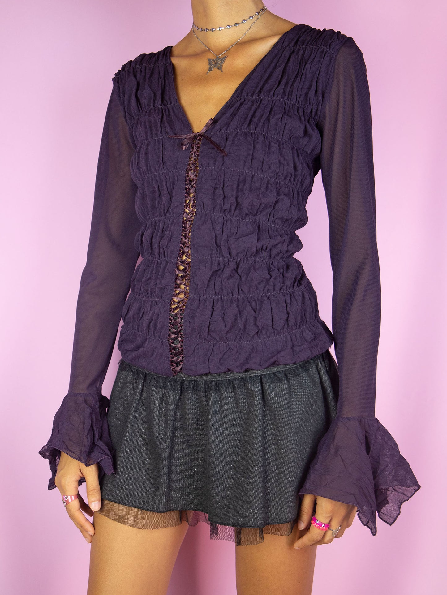 The Y2K Dark Purple Mesh Blouse is a vintage long bell sleeve ruched semi-sheer mesh dark purple top with lace-up front. Romantic fairy grunge whimsygoth 2000s shirt.
