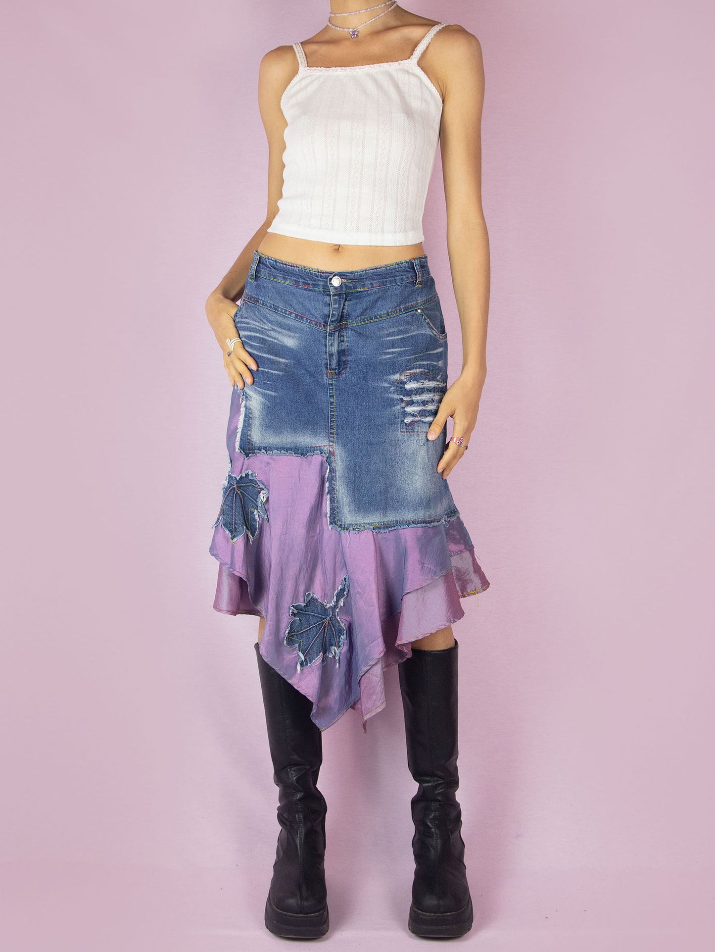The Y2K Denim Asymmetric Trumpet Skirt is a vintage 2000s slightly stretchy jean midi skirt, avant-garde and deconstructed, with applique and acid wash details, a layered pointed hem, pockets, and a zipper closure.