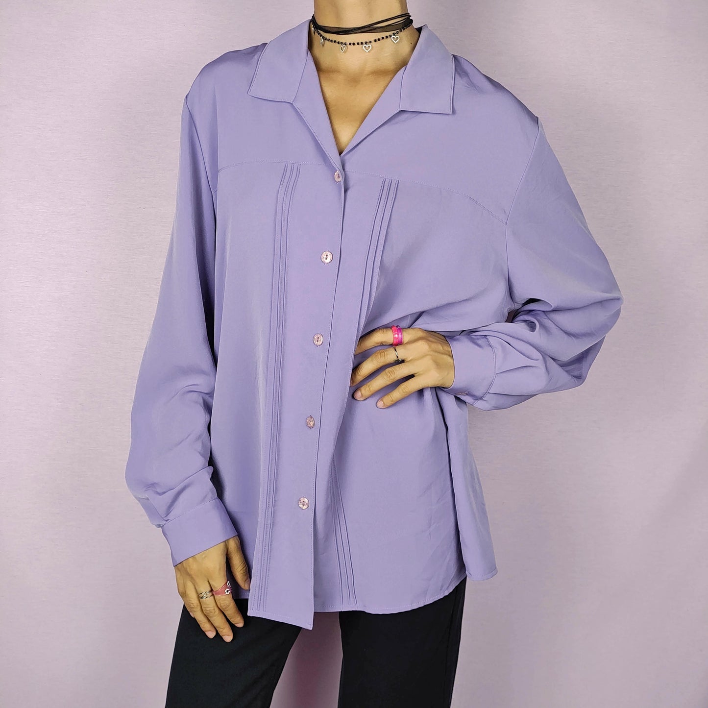 The Vintage 80s Lilac Blouse is a classic shirt featuring a soft, pastel purple hue. This long-sleeve blouse has pintuck details along the front and a pointed collar for an elegant look. The button-up design make it perfect for dressed up for formal occasions or worn casually.
