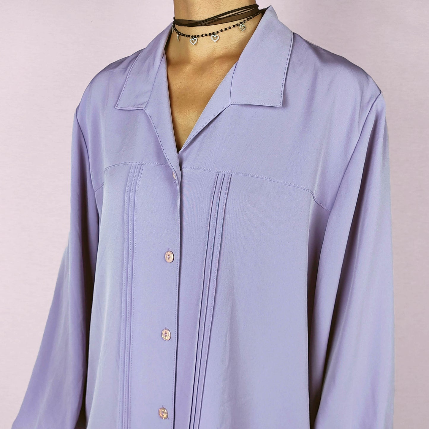 The Vintage 80s Lilac Blouse is a classic shirt featuring a soft, pastel purple hue. This long-sleeve blouse has pintuck details along the front and a pointed collar for an elegant look. The button-up design make it perfect for dressed up for formal occasions or worn casually.