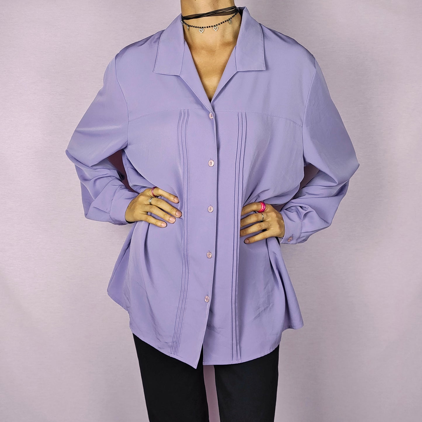 The Vintage 80s Lilac Blouse is a classic shirt featuring a soft, pastel purple hue. This long-sleeve blouse has pintuck details along the front and a pointed collar for an elegant look. The button-up design make it perfect for dressed up for formal occasions or worn casually.