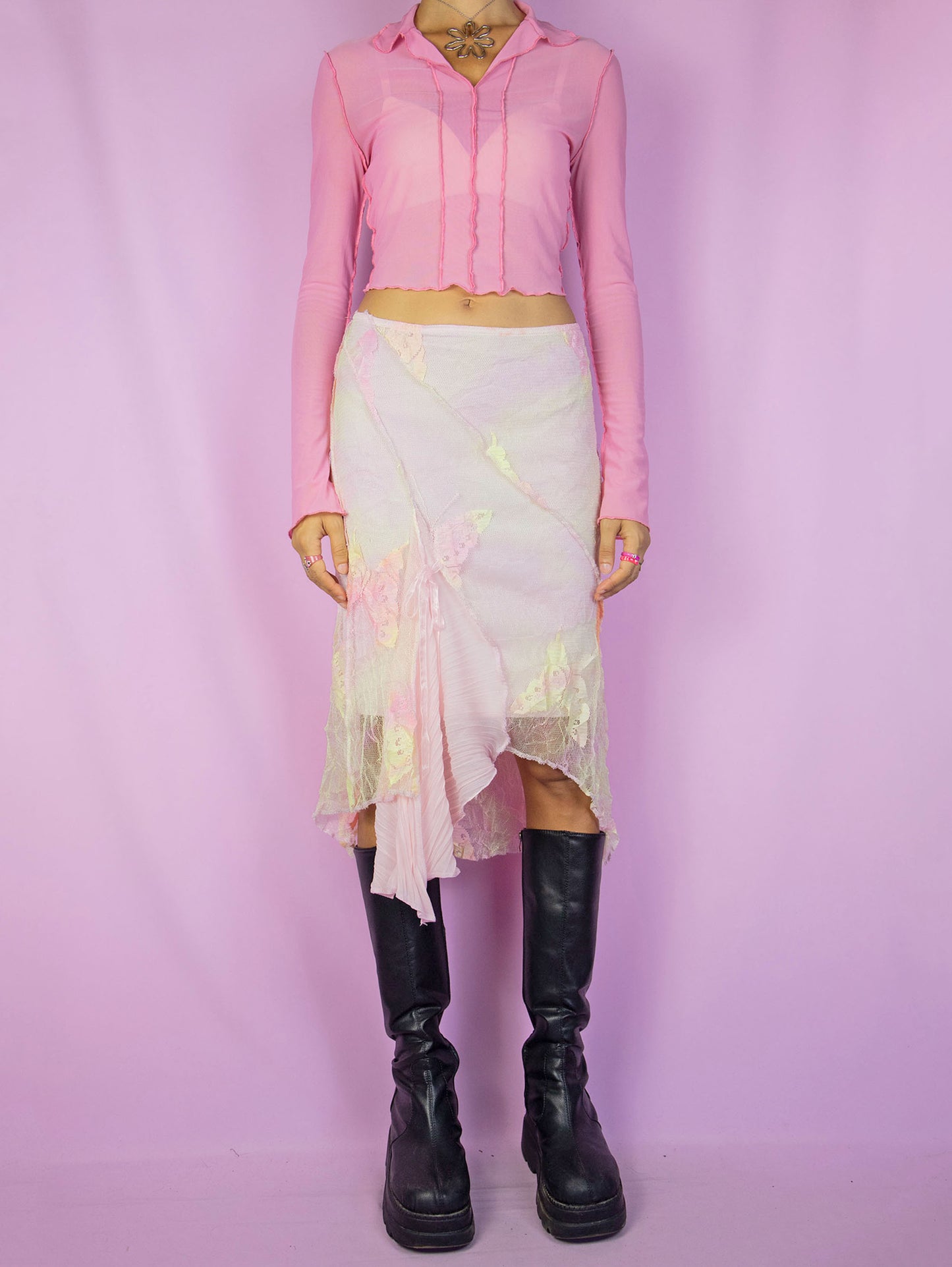 The Y2K Fairy Pink Midi Skirt is a vintage pastel pink, yellow, and orange tie-dye mesh skirt with floral details, an asymmetric hem, and an elastic waistband. A stunning avant-garde romantic coquette-style skirt from the 2000s.