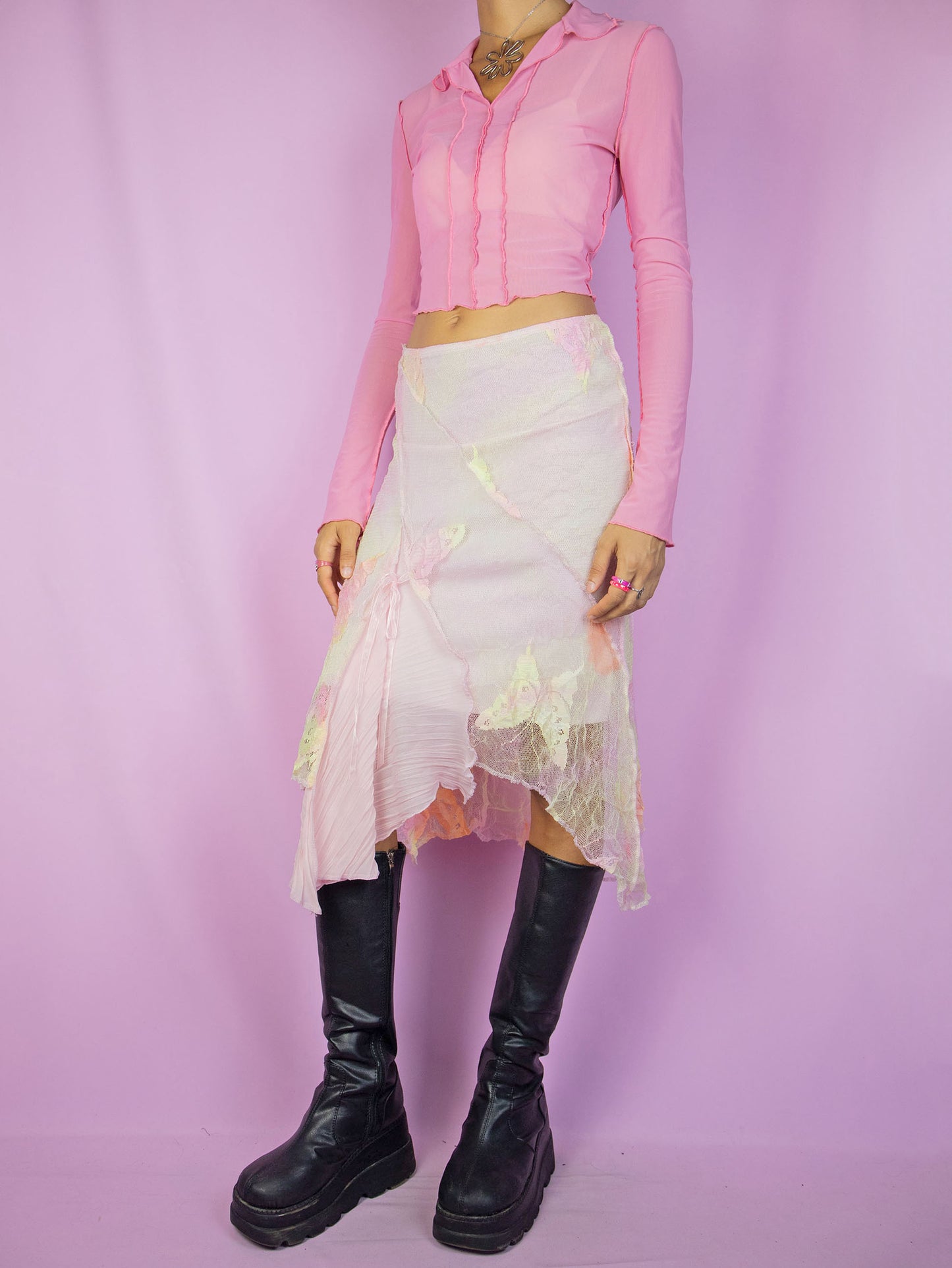 The Y2K Fairy Pink Midi Skirt is a vintage pastel pink, yellow, and orange tie-dye mesh skirt with floral details, an asymmetric hem, and an elastic waistband. A stunning avant-garde romantic coquette-style skirt from the 2000s.