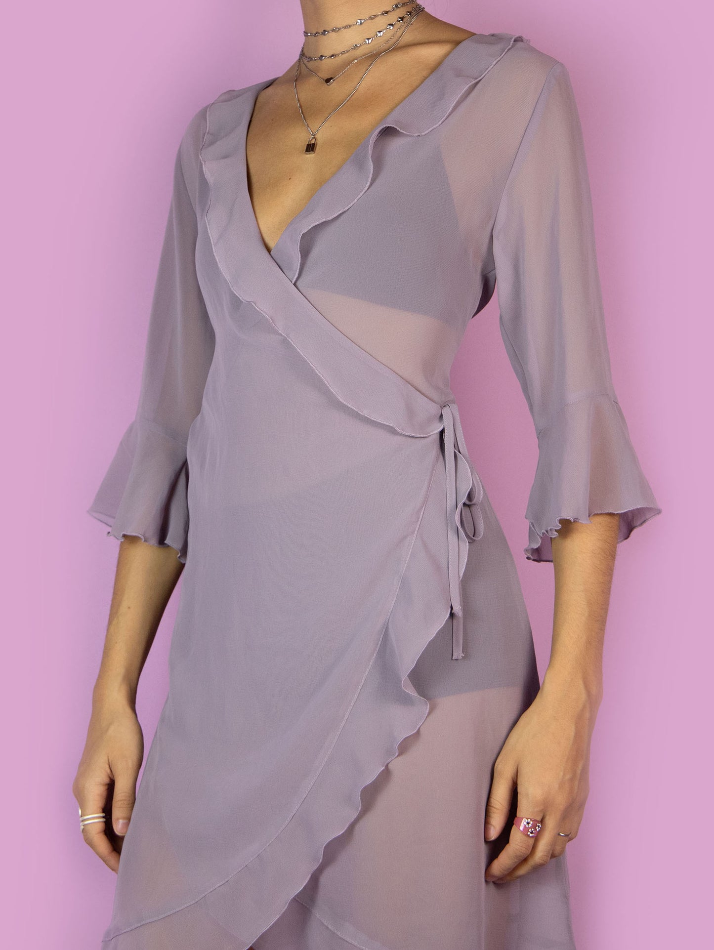 The Y2K Purple Sheer Duster Robe is a vintage dusty purple semi-transparent robe with ruffles, wrapped and tied at the side. Romantic coquette 2000s peignoir jacket.