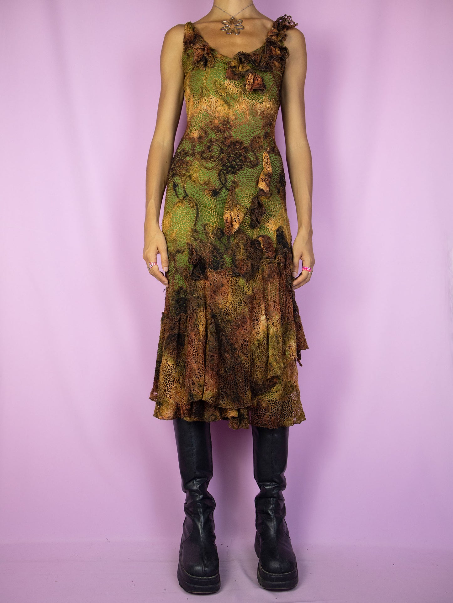 The Y2K Fairy Brown Midi Dress is a vintage sleeveless crochet-style mesh dress with a tie-dye pattern and a green lining. It features a layered ruffled hem, and a charming asymmetric design. Romantic avant-garde 2000s evening party dress.