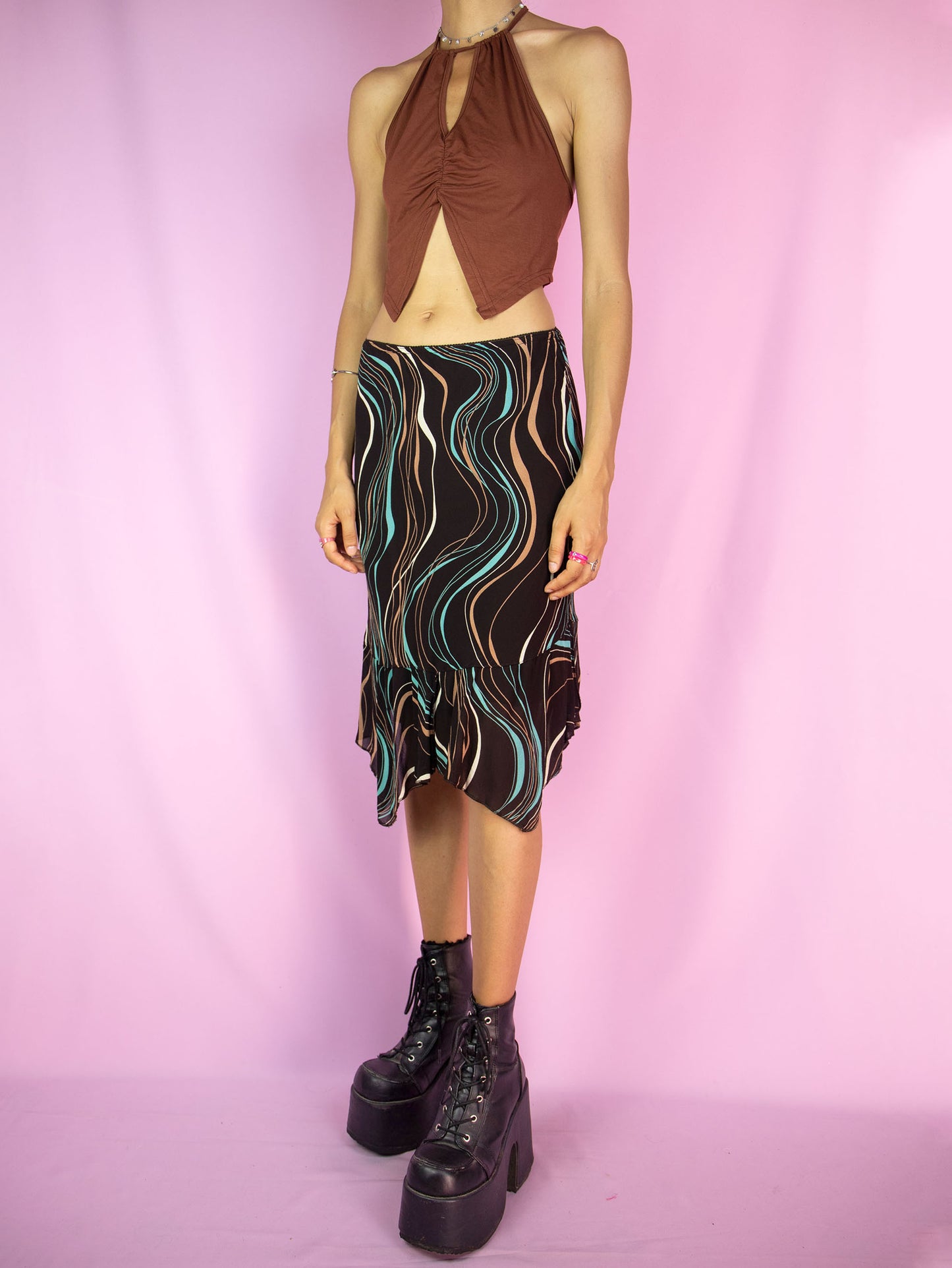 The Y2K Brown Handkerchief Mini Skirt is a vintage abstract striped printed skirt with an elasticated waist, and an asymmetrical pointed hem. Cyber fairy grunge 2000s boho summer midi skirt.