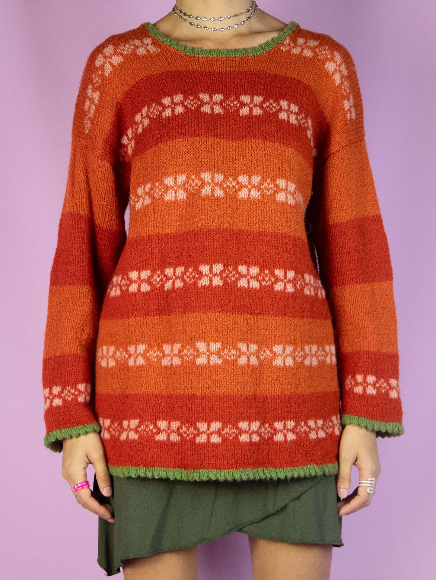 The Vintage 90s Orange Striped Sweater is a winter multicolored orange, white, and green striped pullover.