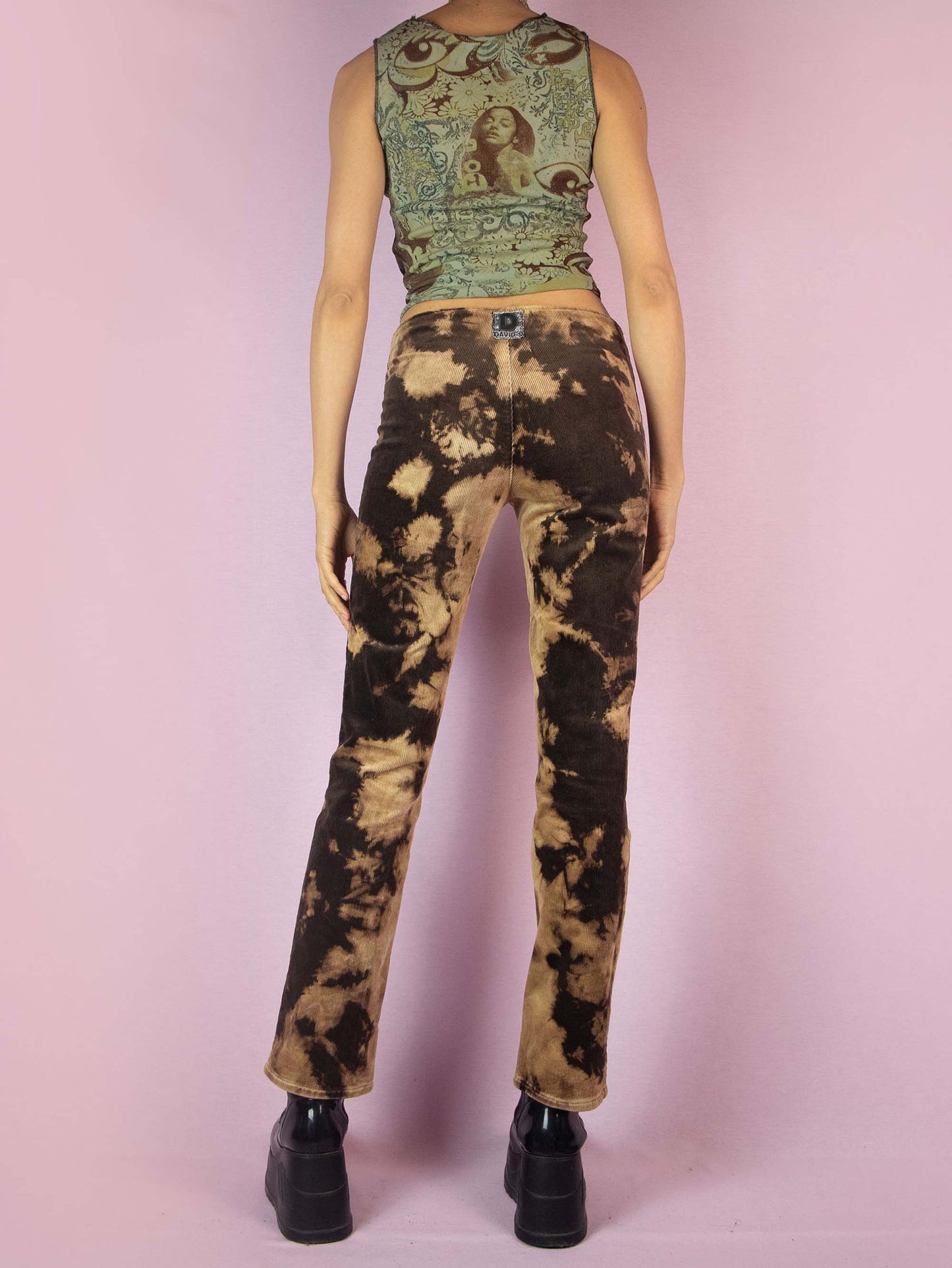 The Vintage 90s Brown Tie Dye Pants are low-rise straight-leg bleached-effect corduroy elastic festival grunge-style pants with button closure.