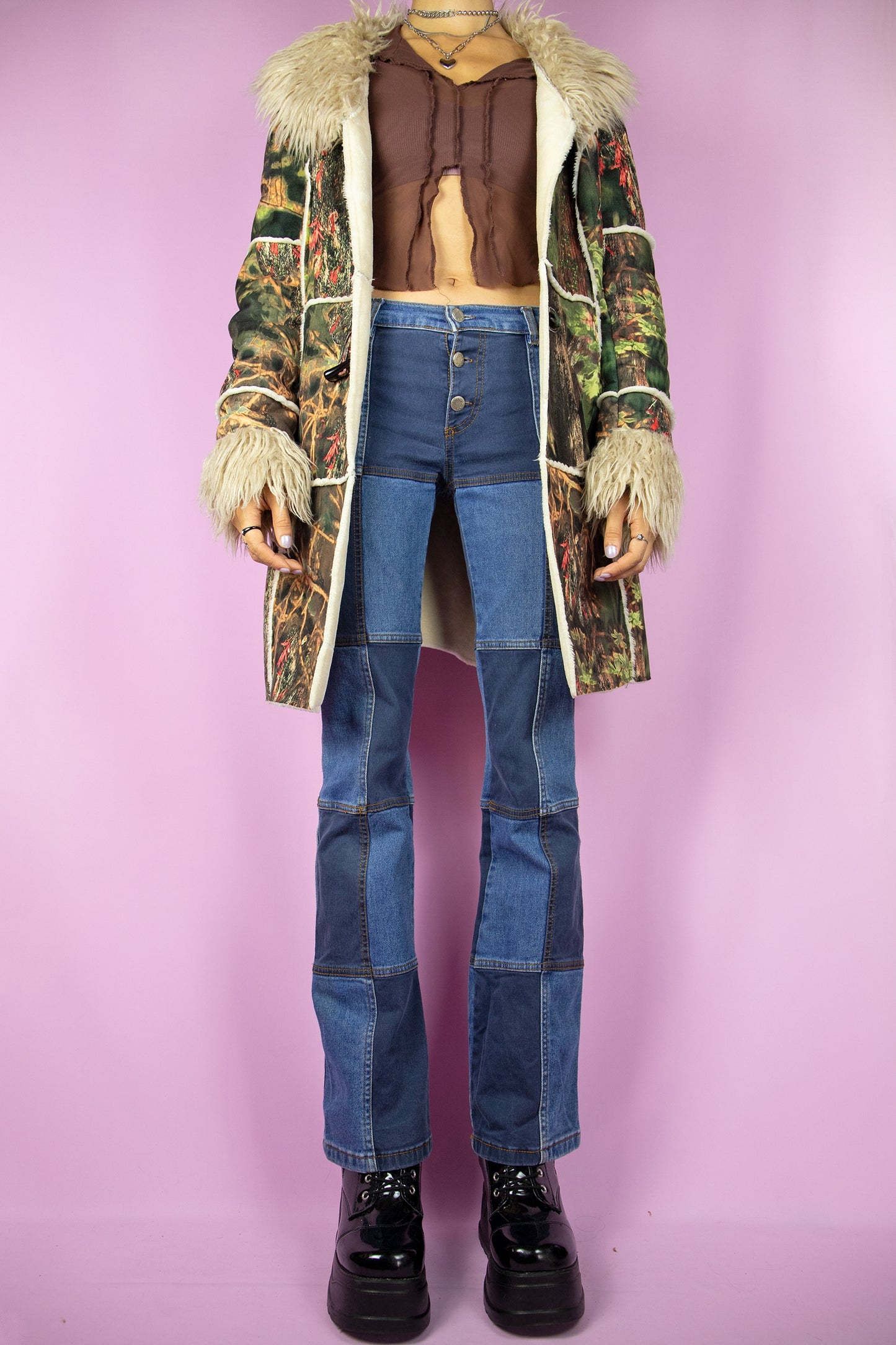 The Y2K Green Penny Lane Coat is a vintage abstract forest graphic printed jacket with beige faux fur collar and cuffs, pockets and toggle closure. Cyber boho 2000s afghan style winter statement coat.