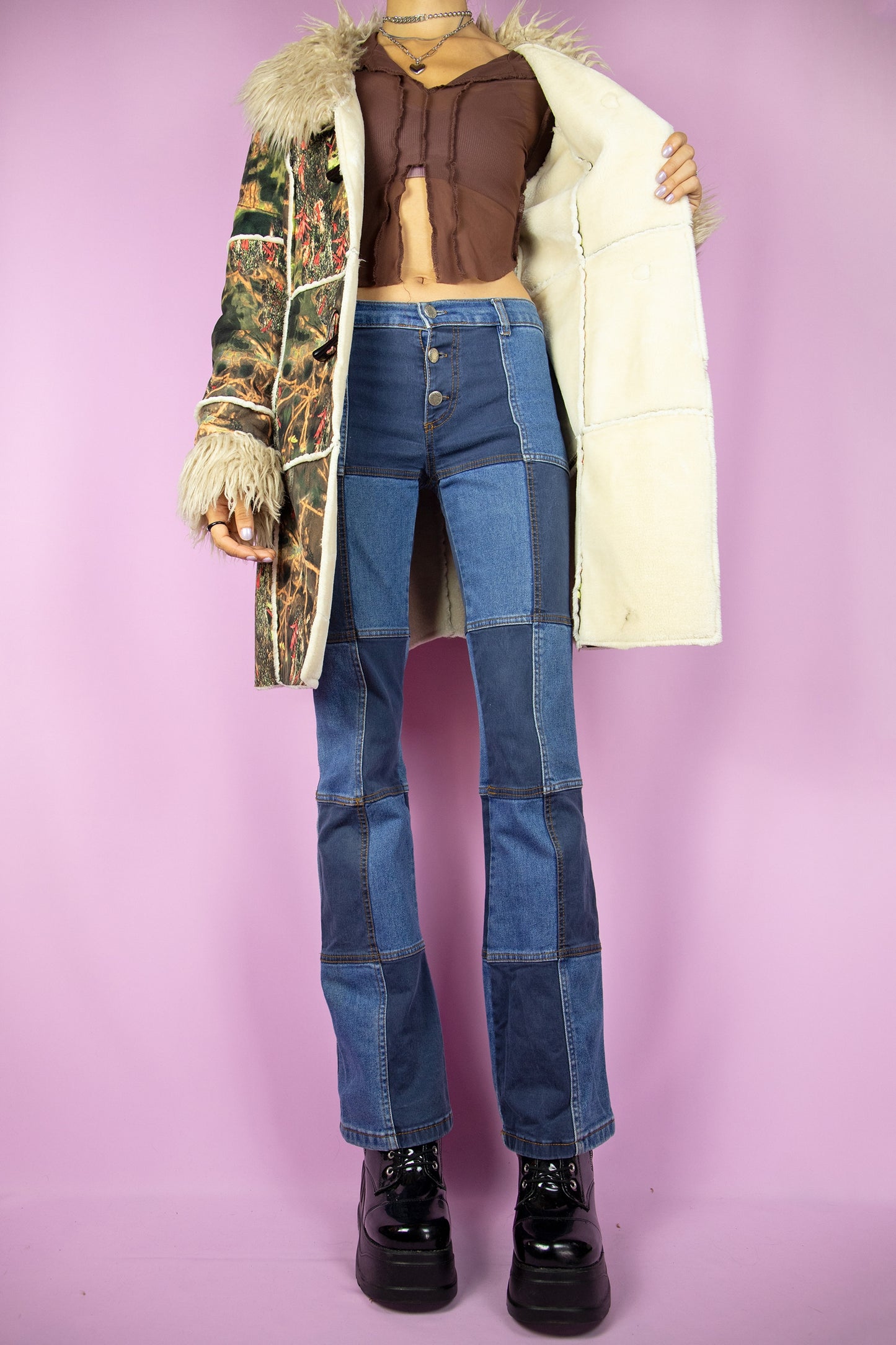 The Y2K Green Penny Lane Coat is a vintage abstract forest graphic printed jacket with beige faux fur collar and cuffs, pockets and toggle closure. Cyber boho 2000s afghan style winter statement coat.
