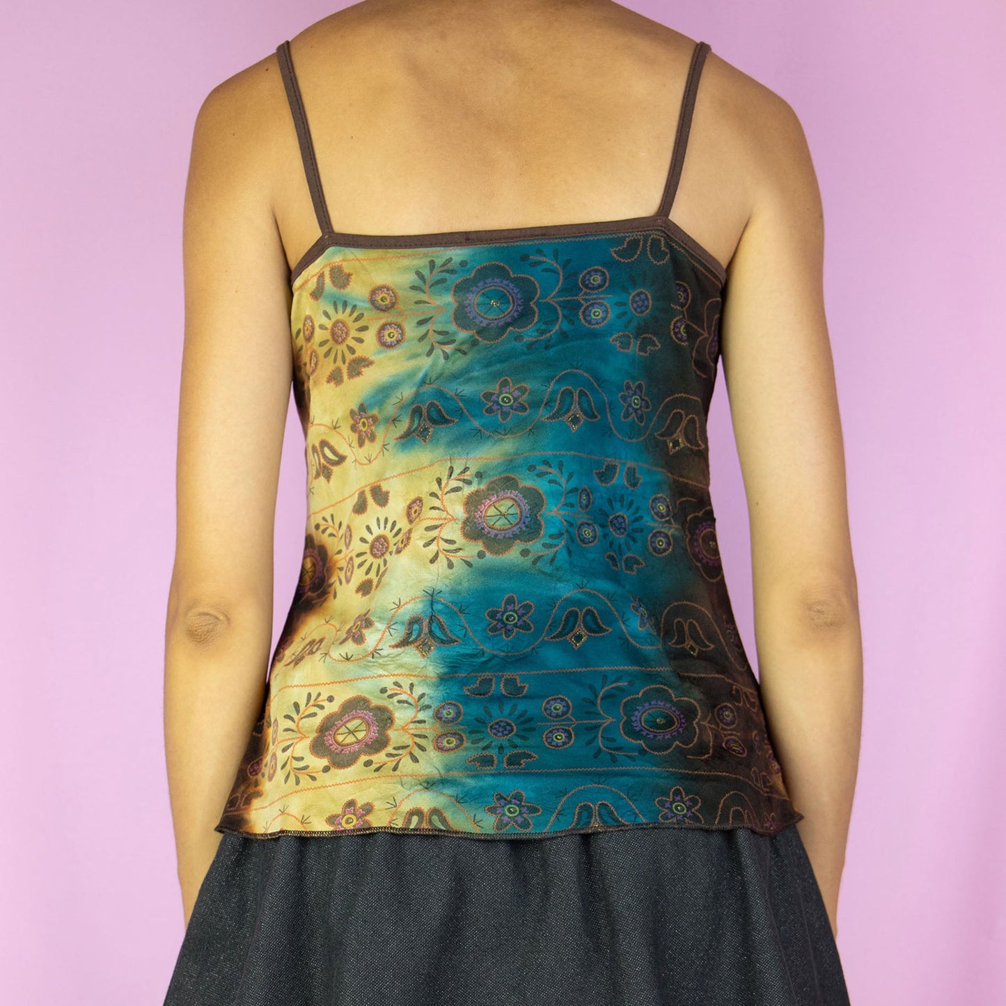 The Y2K Fairy Ruffle Cami Top is a vintage blue and brown multicolored tie-dye floral pattern tank top with a ruffled, ruched front. Boho grunge 2000s summer shirt.