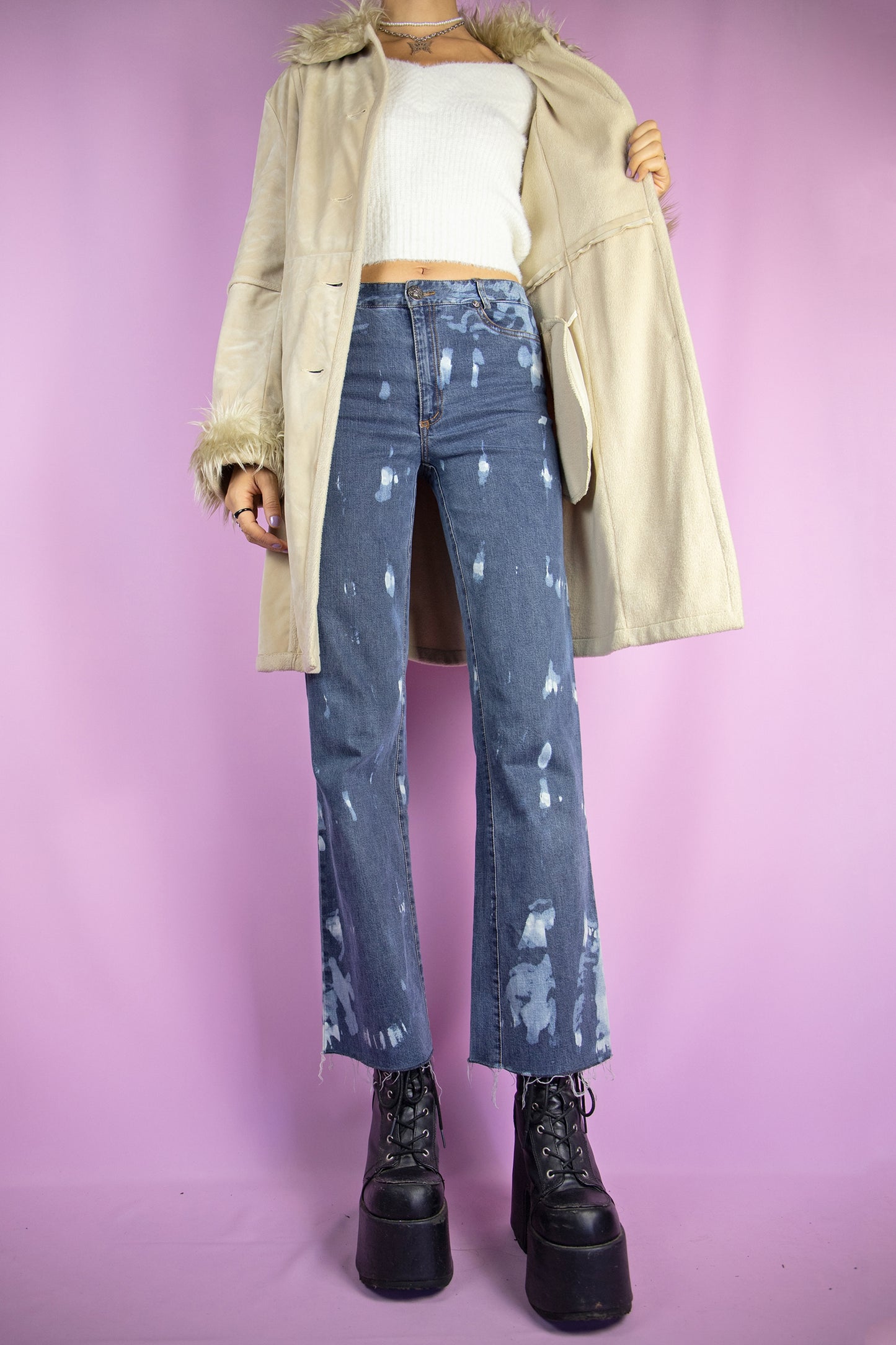 The Y2K Beige Penny Lane Jacket is a vintage 2000s winter faux suede statement coat showcasing faux fur collar and cuffs, along with pockets, buttons, and a coordinating belt.