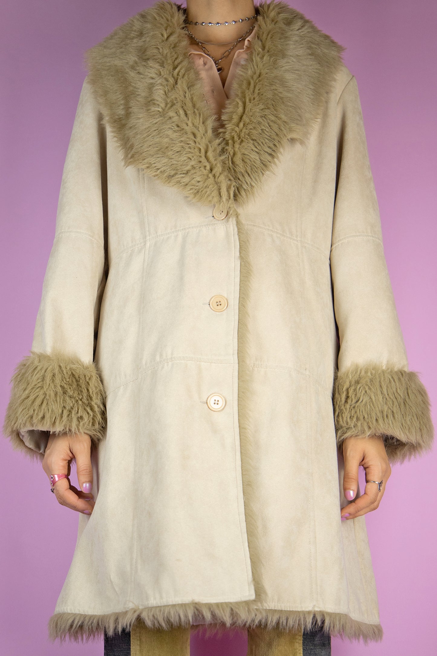 The Y2K Beige Penny Lane Coat is a vintage beige faux suede coat with light brown faux fur collar and cuffs, button closure and pockets. Iconic cyber afghan style 2000s winter statement jacket.