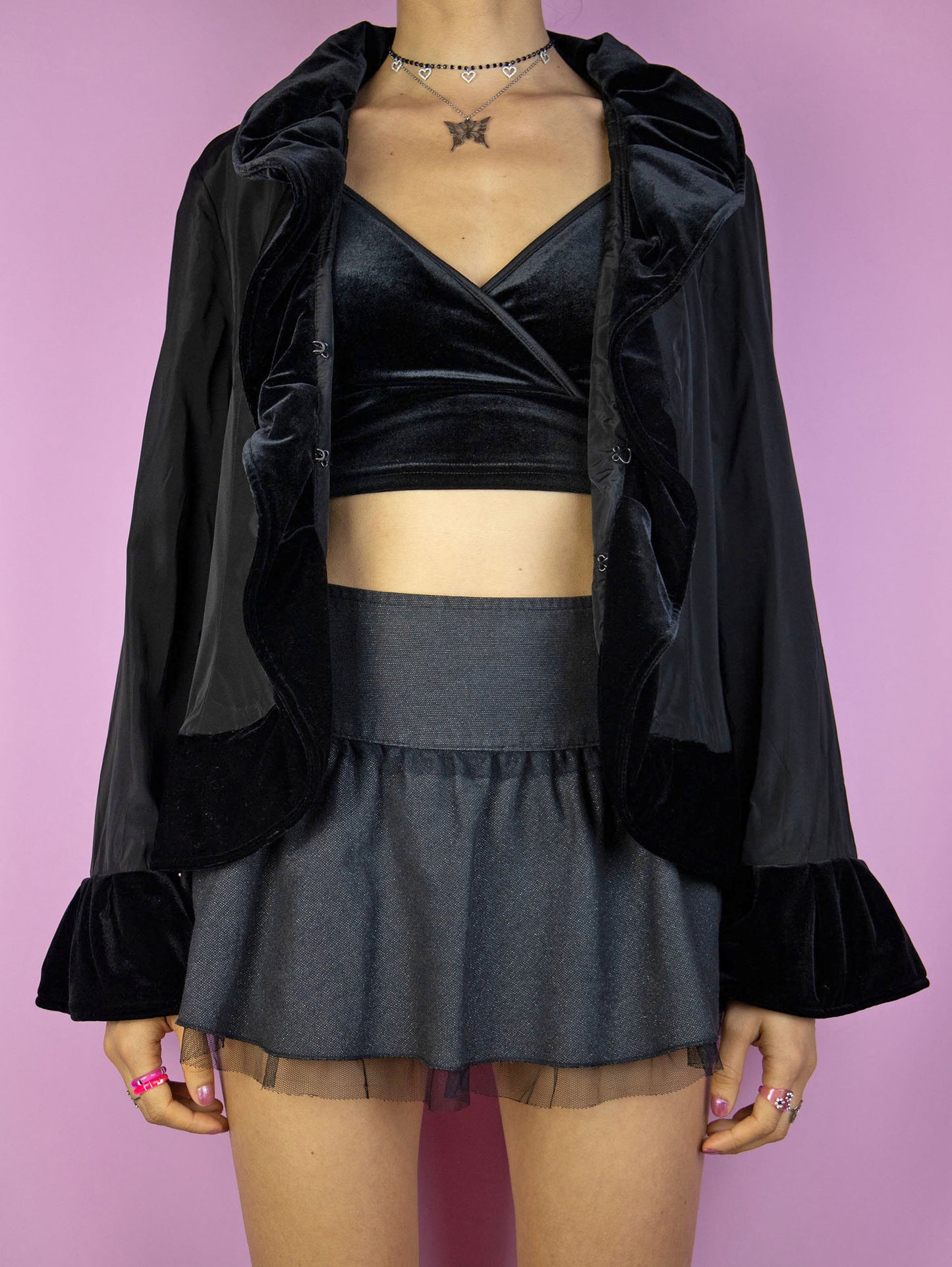 The Vintage 90s Black Ruffle Jacket is an elegant, romantic, whimsygoth-inspired statement piece, featuring velvet ruffle details and a front hook closure.
