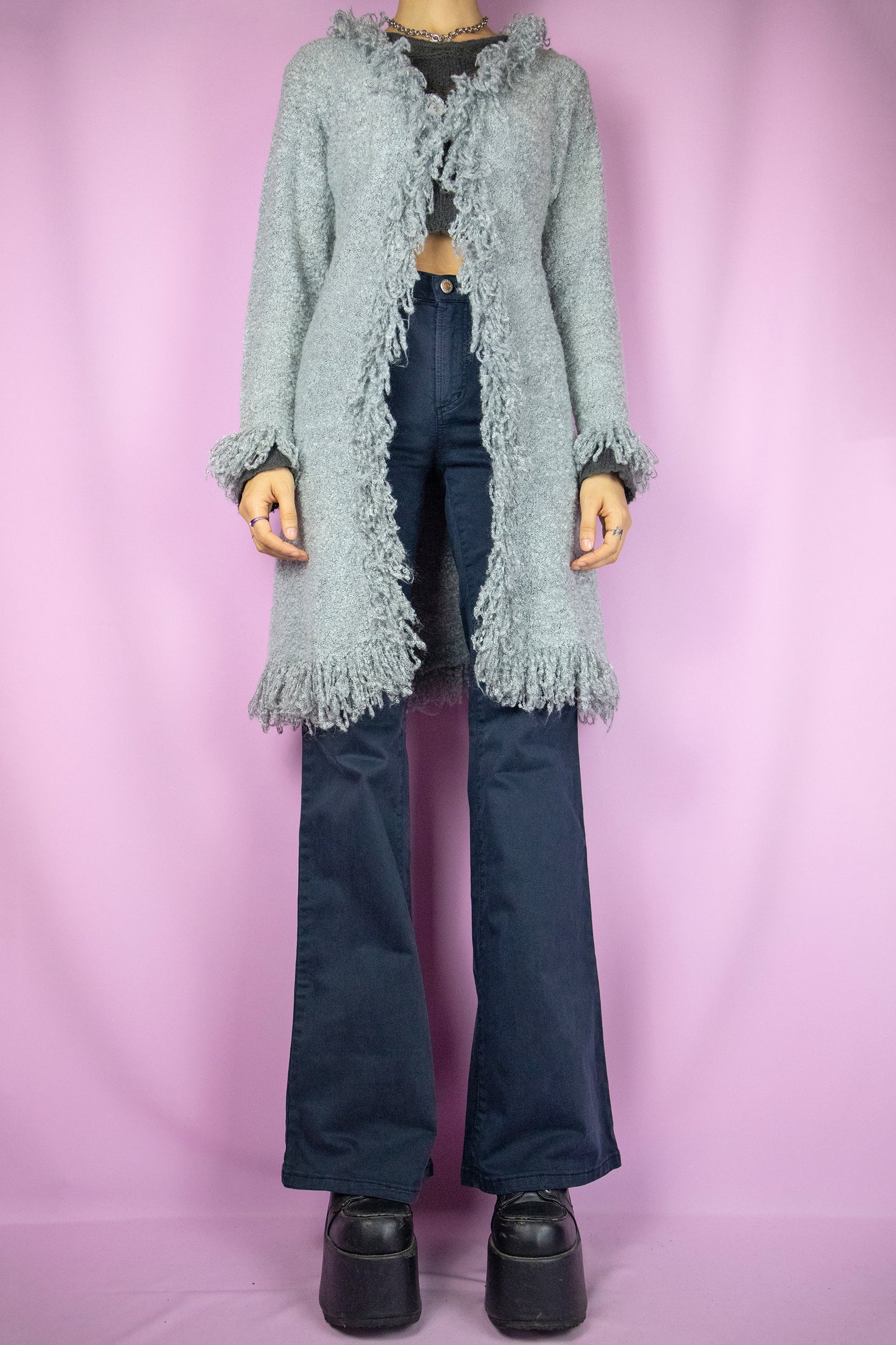 The Y2K Gray Penny Lane Cardigan is a vintage long shaggy knit cardigan with a one button closure and fringe trim at the neckline and cuffs. Cyber fairy grunge 2000s boho duster jacket.