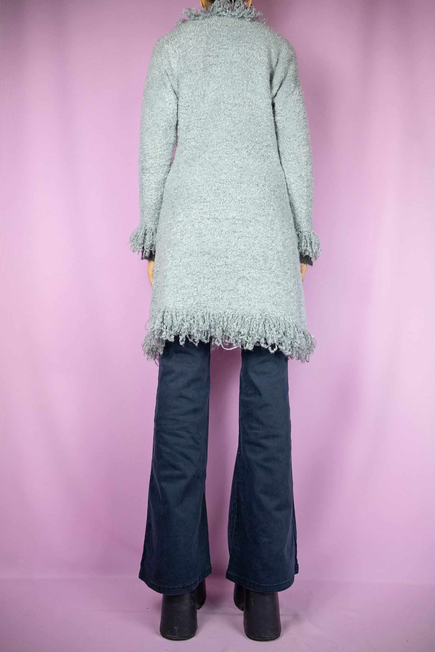 The Y2K Gray Penny Lane Cardigan is a vintage long shaggy knit cardigan with a one button closure and fringe trim at the neckline and cuffs. Cyber fairy grunge 2000s boho duster jacket.