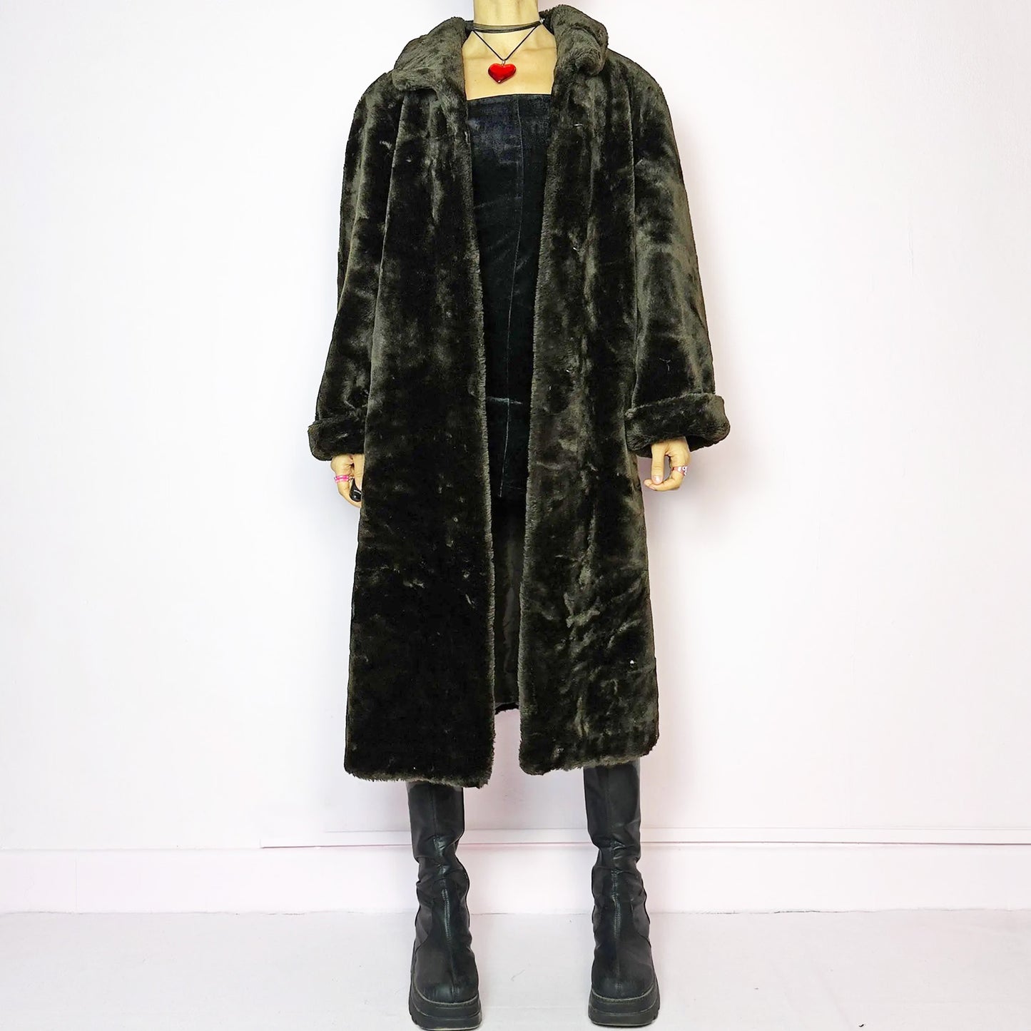 The Vintage 90s Brown Faux Fur Maxi Coat is a luxurious and warm winter essential. This long coat features a plush faux fur design in a deep brown hue, a wide collar and a pullover front closure. Its full length make it perfect for cozy and elegant winter outfits. A statement coat that embodies 90s glamour with timeless appeal. Made from a polyester faux fur blend. Excellent vintage condition.