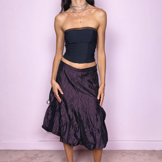 This vintage 90s dark purple iridescent midi skirt features a bubble balloon hem and adjustable ruched drawstrings at the sides, allowing for a sculptural, futuristic silhouette. Crafted from textured crinkle fabric with a back zipper closure and no stretch. A rare statement piece merging cyber, dystopian, and techwear aesthetics with Harajuku grunge edge. Can be worn high-waisted for size XL or mid-rise for size L. Excellent vintage condition.