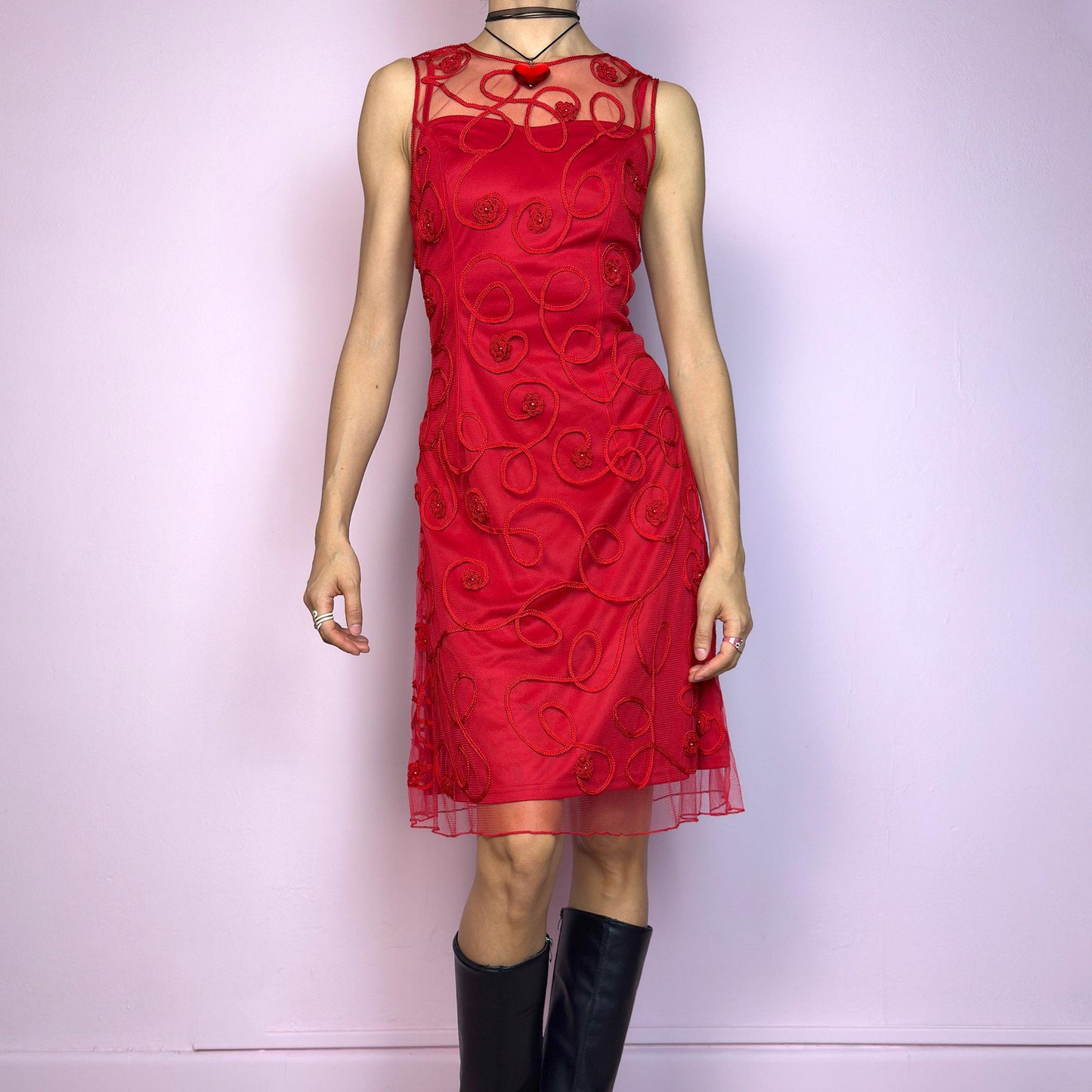 The Vintage 90s Red Mesh Cocktail Dress is a striking sheer-layered piece featuring a sculpted fit with a delicate mesh overlay. Adorned with spiral embroidery and floral appliqué details, this sleeveless dress has a sheer upper neckline for added drama. It’s fully lined and fastens with a back zipper closure. A bold romantic look, ideal for date nights, special events and Valentine’s-inspired outfits. Great vintage condition.