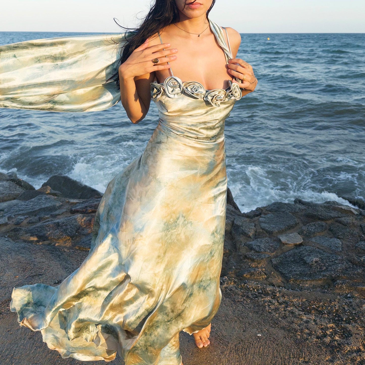 The vintage 2000s pastel tie-dye slip dress is a French-made fantasy in soft blues, greens, and gold. With sculptural rosette appliqué along the bust and a matching scarf, it moves like light on water. The shiny satin-style finish and fluid midi length evoke fairytale softness—ideal for proms, weddings, or summer nights. A romantic Y2K archive crafted from a shimmering non-stretch polyester blend. Great vintage condition.