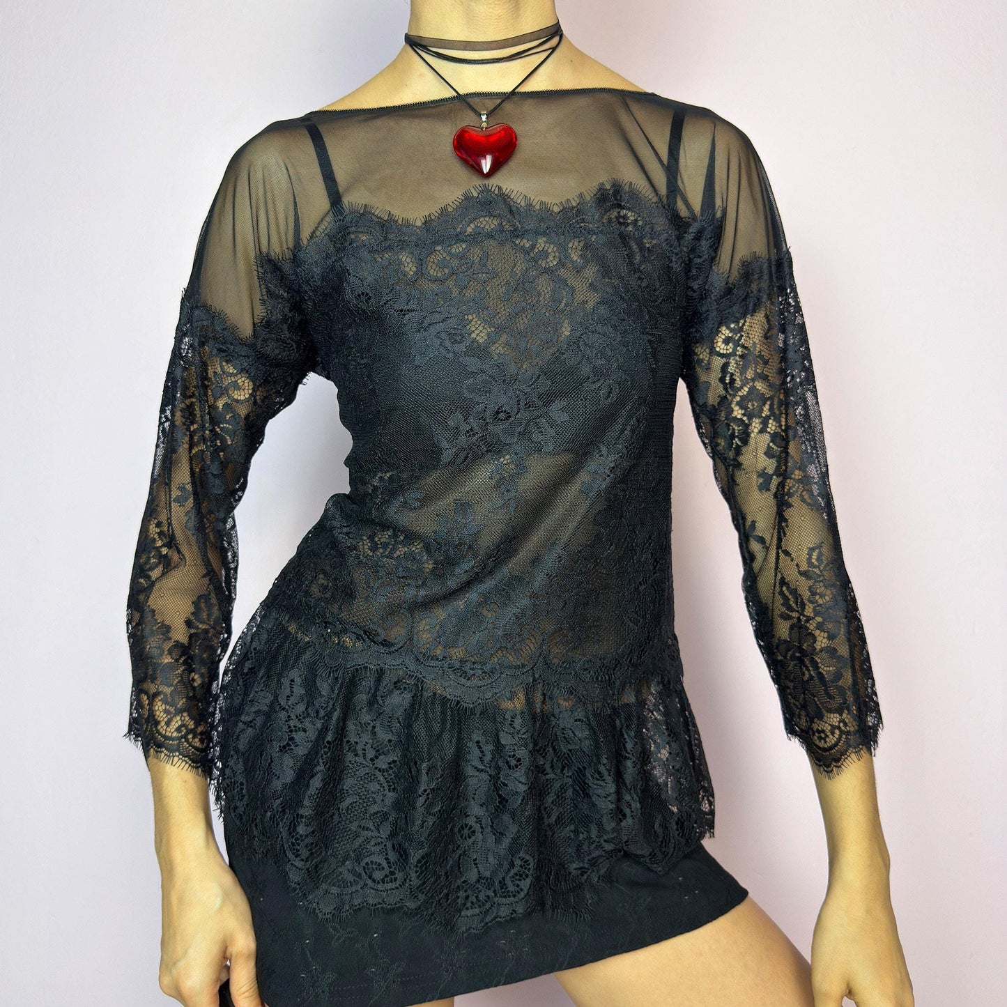 The Y2K Black Lace Peplum Top is a vintage 2000s piece featuring sheer mesh panels, floral lace detailing, and a flattering peplum hem. Designed with three-quarter length sleeves and a boat neckline for an elegant yet sultry silhouette. Perfect for layering or styling for a night out. Stretchy and lightweight for a comfortable fit. Excellent vintage condition. adult world shop