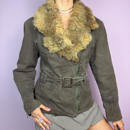 The Y2K Khaki Belted Jacket is a vintage 2000s piece featuring a structured fit with rugged utility-inspired details. Designed with padded shoulders for a strong silhouette, an oversized plush faux-shearling collar, asymmetric zip closure, and an adjustable waist belt for a cinched look. The washed khaki tone and distressed finish add to its edgy, worn-in appeal, making it perfect for grunge or military-inspired winter outfits. A outerwear piece for layering in colder seasons. adult world shop