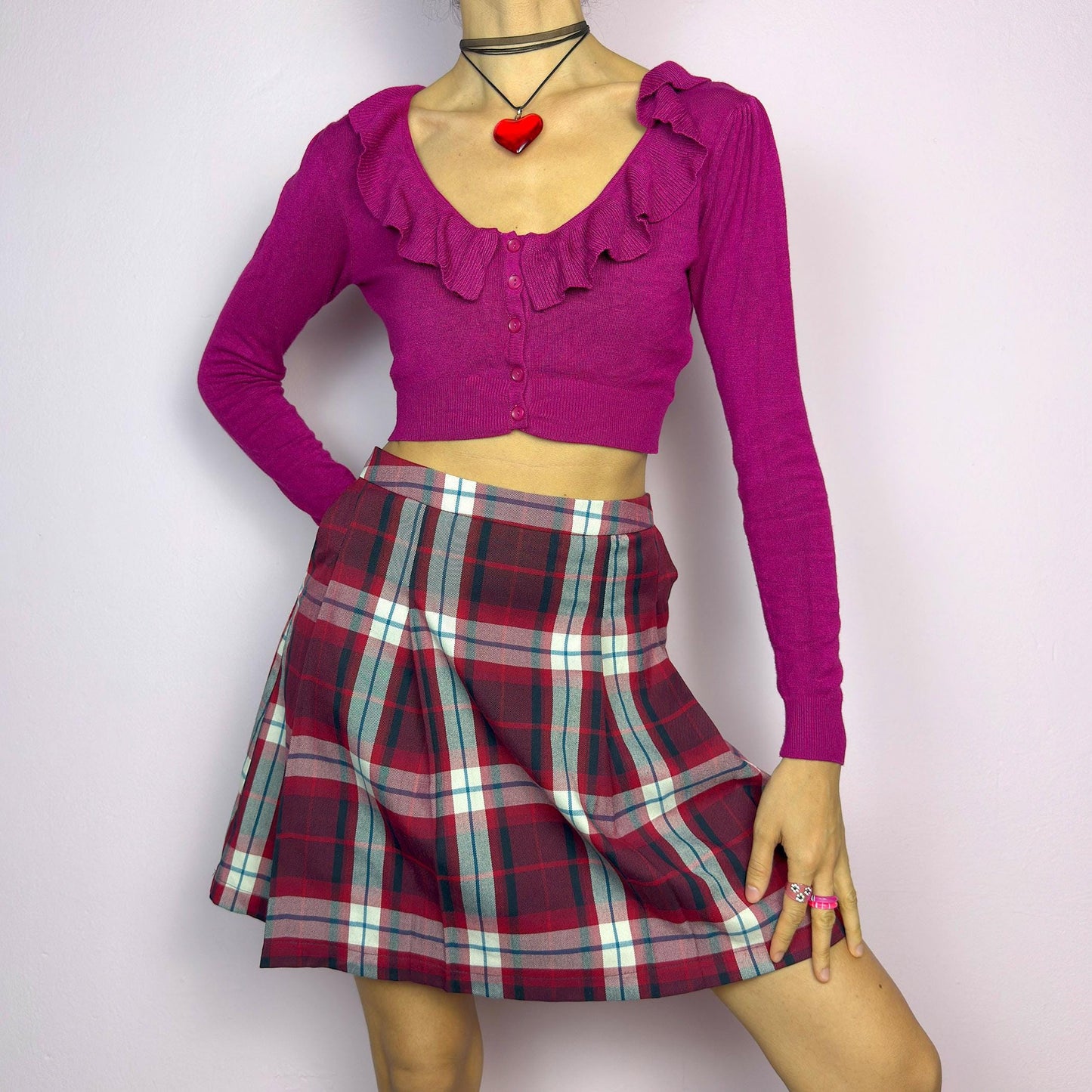 The Y2K Red Plaid Pleated Mini Skirt is a vintage 2000s essential featuring a structured pleated design in a bold red, navy, and white plaid pattern. Made from a woven fabric, it’s perfect for preppy, punk, or casual outfits. adult world shop