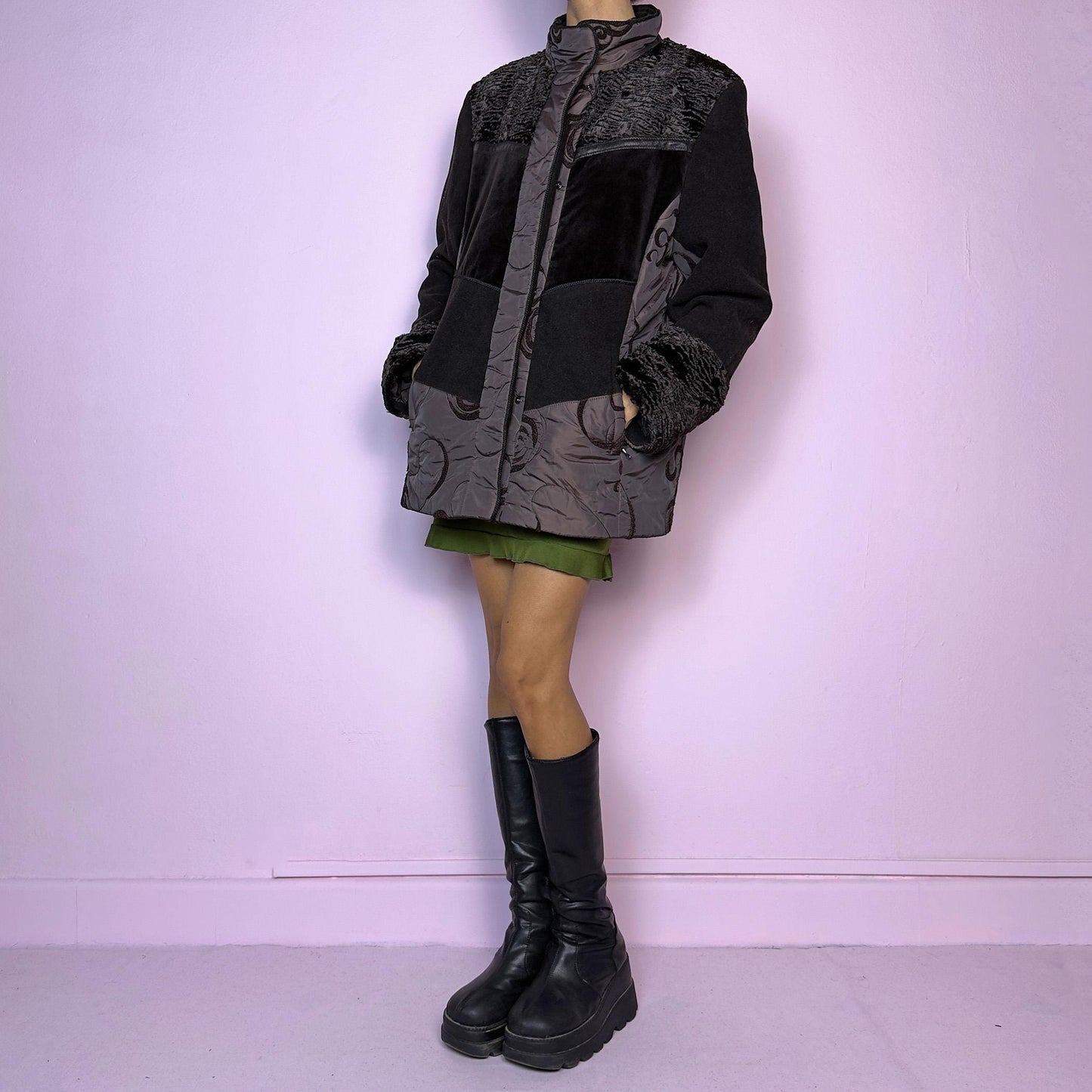The Y2K Brown Contrast Panel Jacket is a vintage 2000s piece featuring a striking mixed-material design in dark brown with textured panels, including quilted, faux fur, and velvety fabric sections. It comes with a zipper and snap button closure