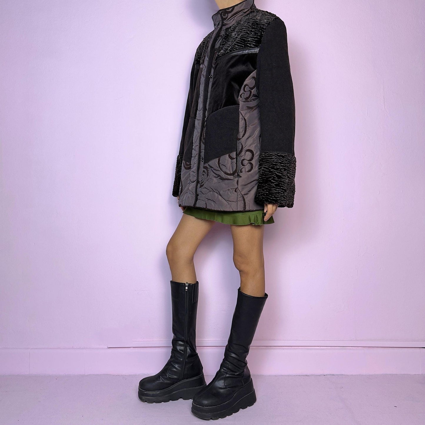The Y2K Brown Contrast Panel Jacket is a vintage 2000s piece featuring a striking mixed-material design in dark brown with textured panels, including quilted, faux fur, and velvety fabric sections. It comes with a zipper and snap button closure