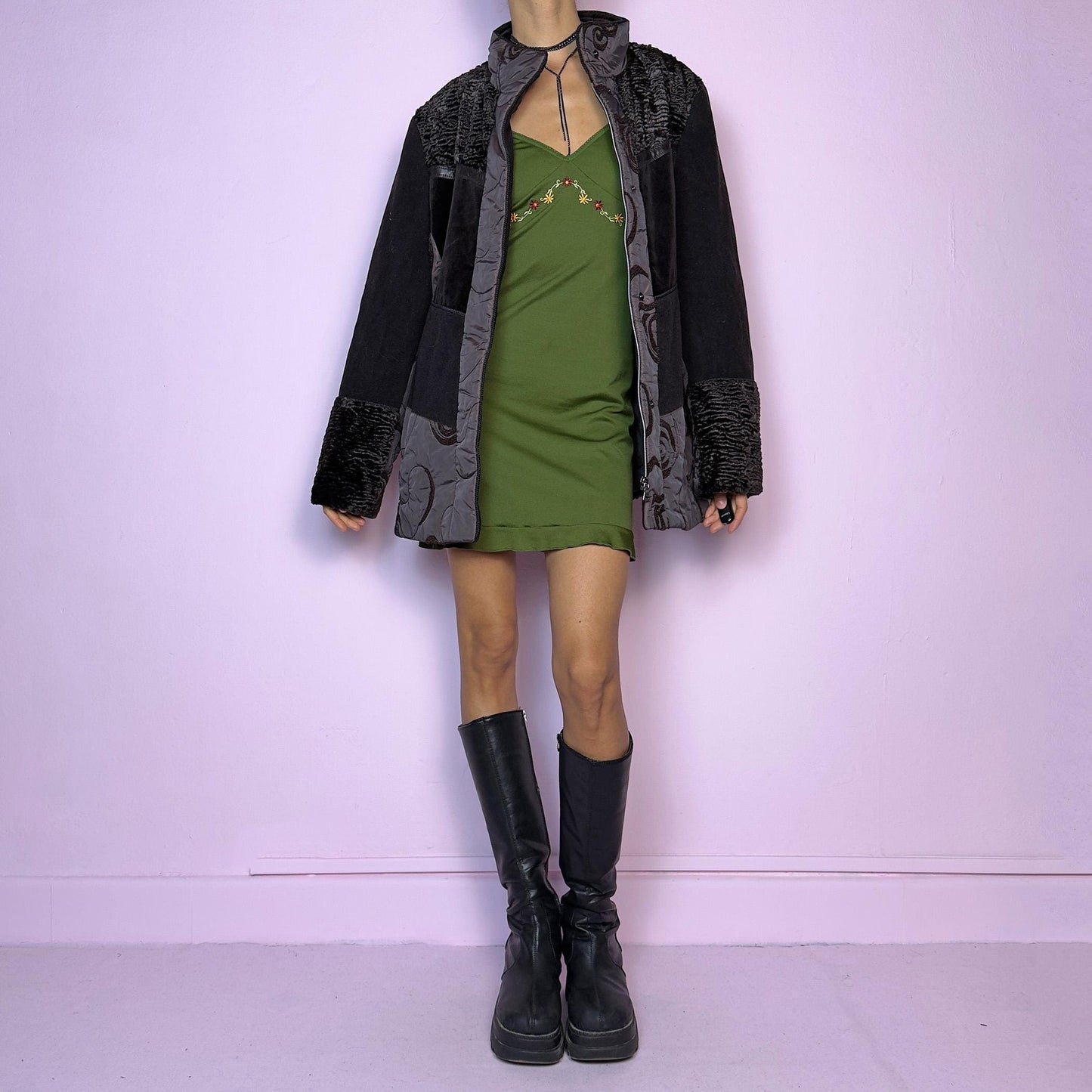 The Y2K Brown Contrast Panel Jacket is a vintage 2000s piece featuring a striking mixed-material design in dark brown with textured panels, including quilted, faux fur, and velvety fabric sections. It comes with a zipper and snap button closure