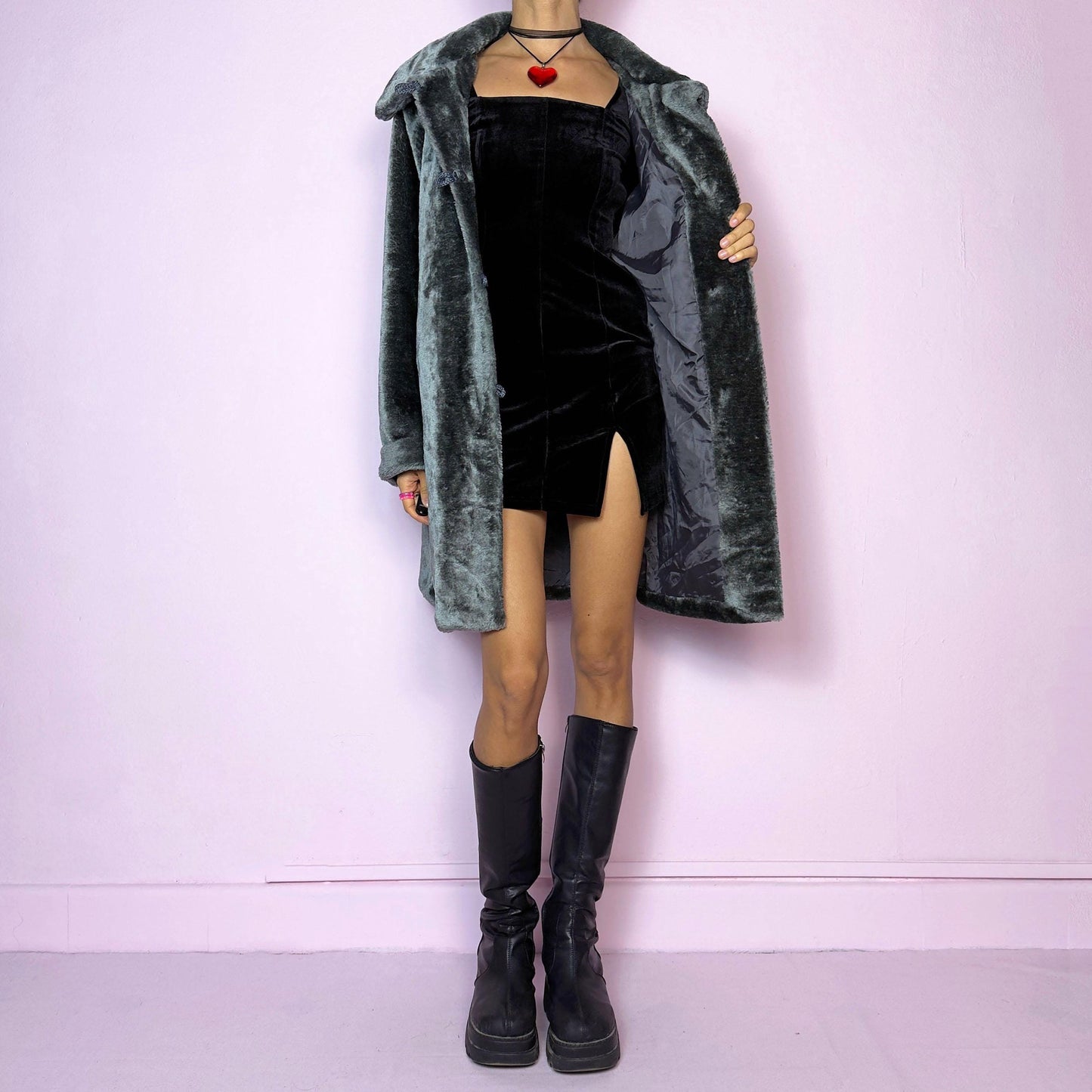 The Vintage 90s Gray Faux Fur Coat is a cozy and stylish outerwear piece featuring a plush faux fur design, a toggle-front closure, a wide collar, and pockets. Perfect for your winter wardrobe.