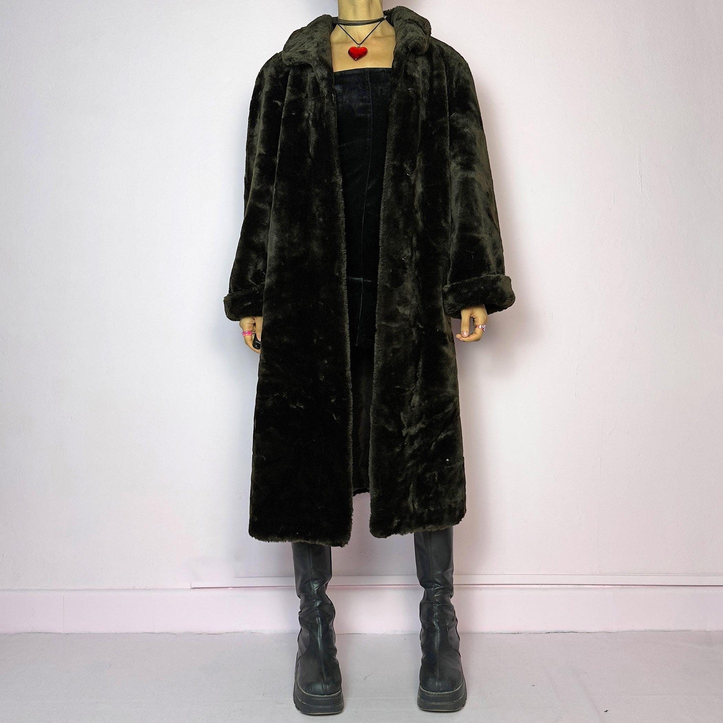 The Vintage 90s Brown Faux Fur Maxi Coat is a luxurious and warm winter essential. This long coat features a plush faux fur design in a deep brown hue, a wide collar and a pullover front closure. Its full length make it perfect for cozy