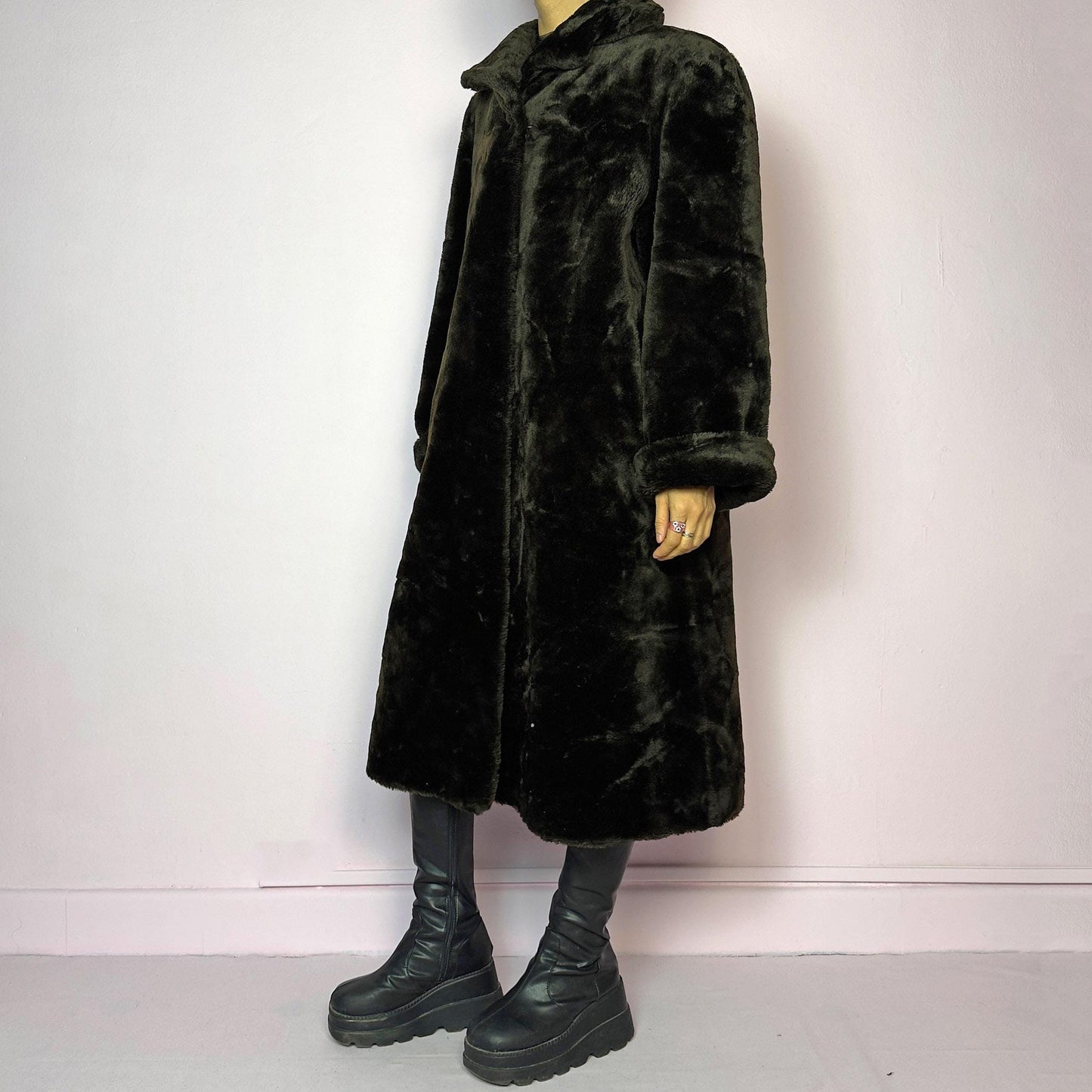 The Vintage 90s Brown Faux Fur Maxi Coat is a luxurious and warm winter essential. This long coat features a plush faux fur design in a deep brown hue, a wide collar and a pullover front closure. Its full length make it perfect for cozy