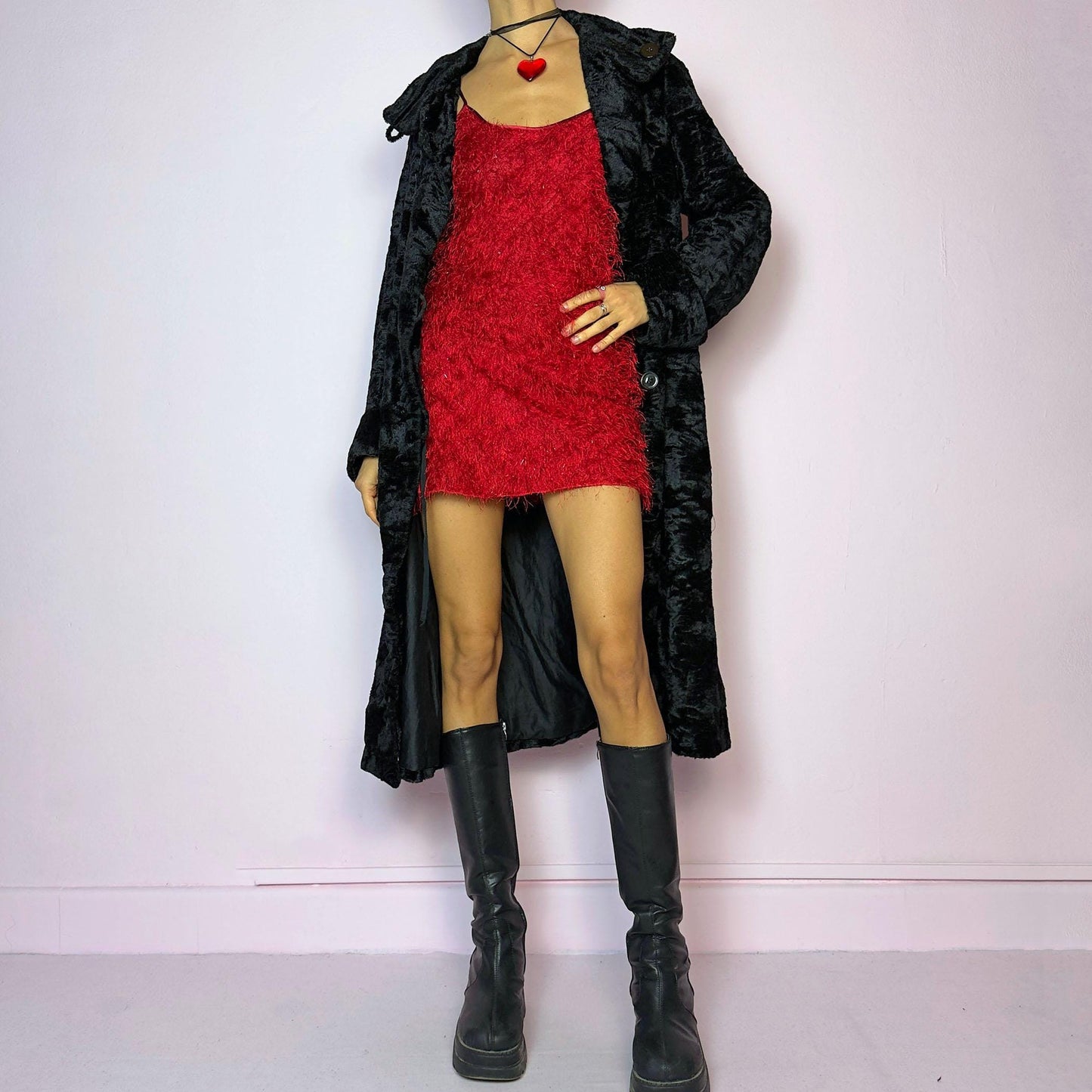 The Vintage 90s Black Faux Fur Long Coat features a plush faux fur exterior for a cozy feel. Designed with a button front closure, it includes long sleeves and pockets. Its longline silhouette makes it a chic and warm choice for winter evenings