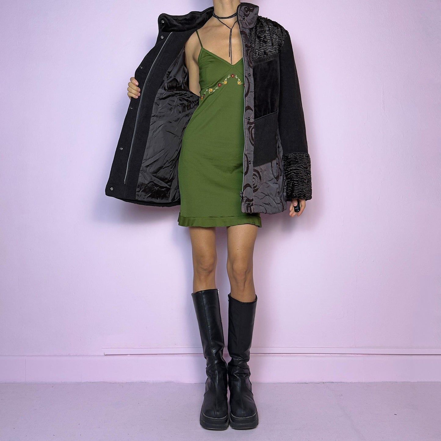 The Y2K Brown Contrast Panel Jacket is a vintage 2000s piece featuring a striking mixed-material design in dark brown with textured panels, including quilted, faux fur, and velvety fabric sections. It comes with a zipper and snap button closure