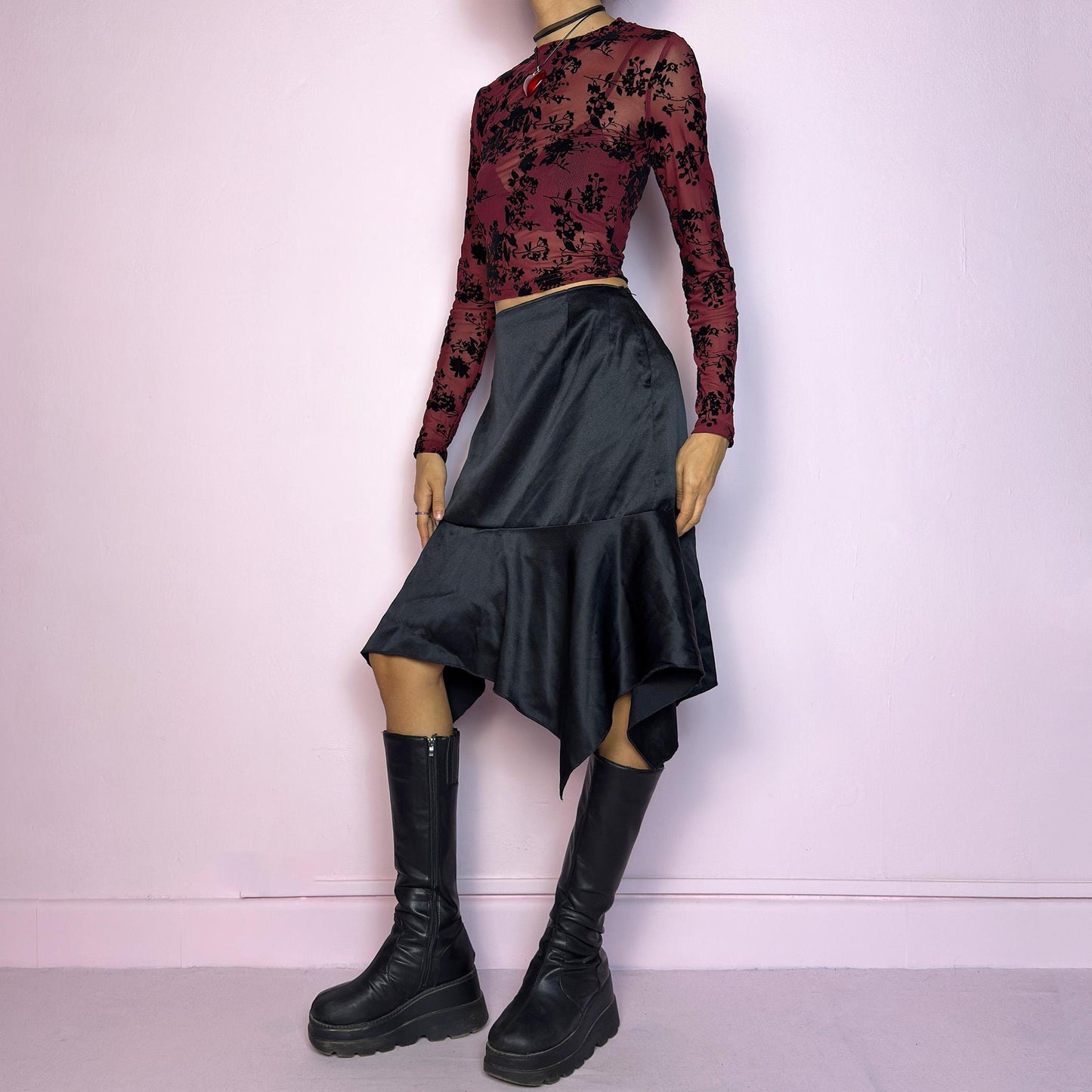 The Y2K Black Satin Asymmetric Skirt is a vintage 2000s stylish piece, featuring a satin-like finish with an asymmetrical handkerchief hemline for a dramatic flair and a size zipper closure. Perfect choice for party nights. Adult World Shop