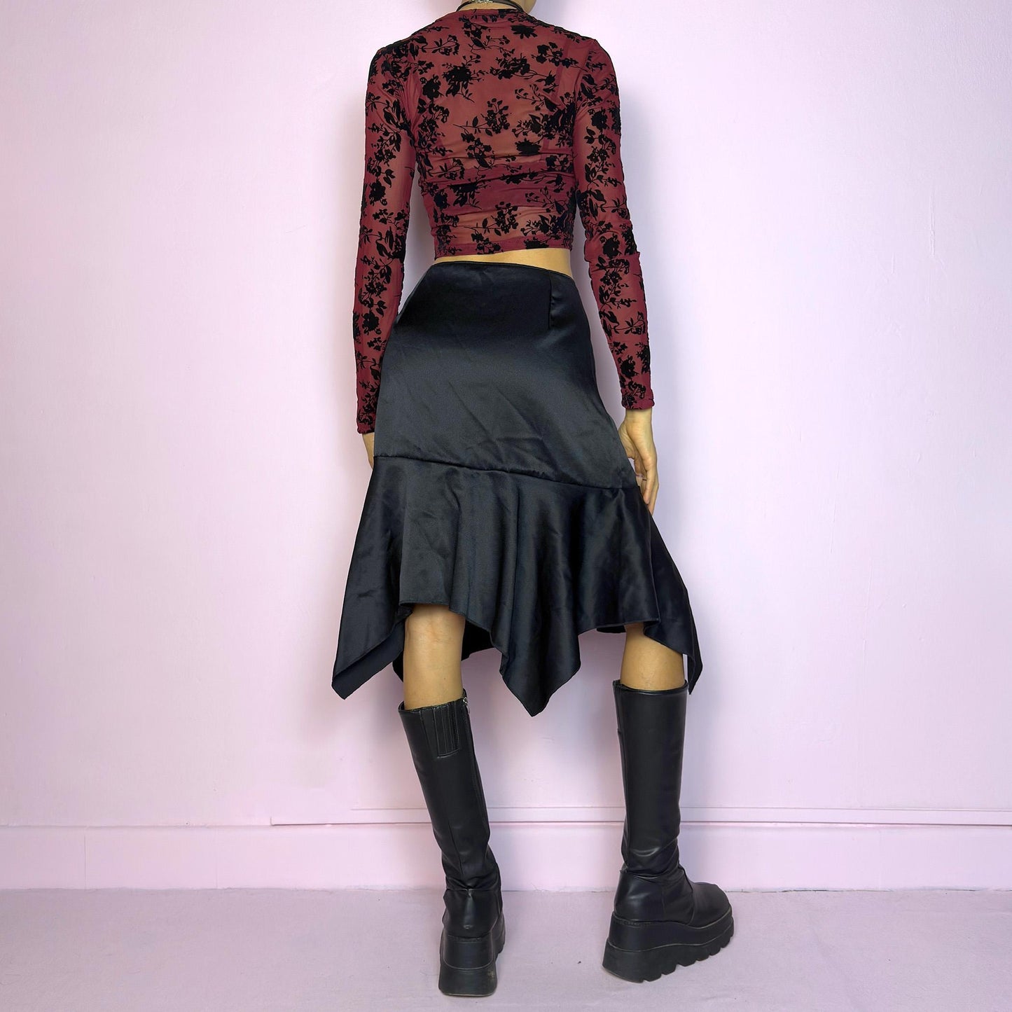 The Y2K Black Satin Asymmetric Skirt is a vintage 2000s stylish piece, featuring a satin-like finish with an asymmetrical handkerchief hemline for a dramatic flair and a size zipper closure. Perfect choice for party nights. Adult World Shop