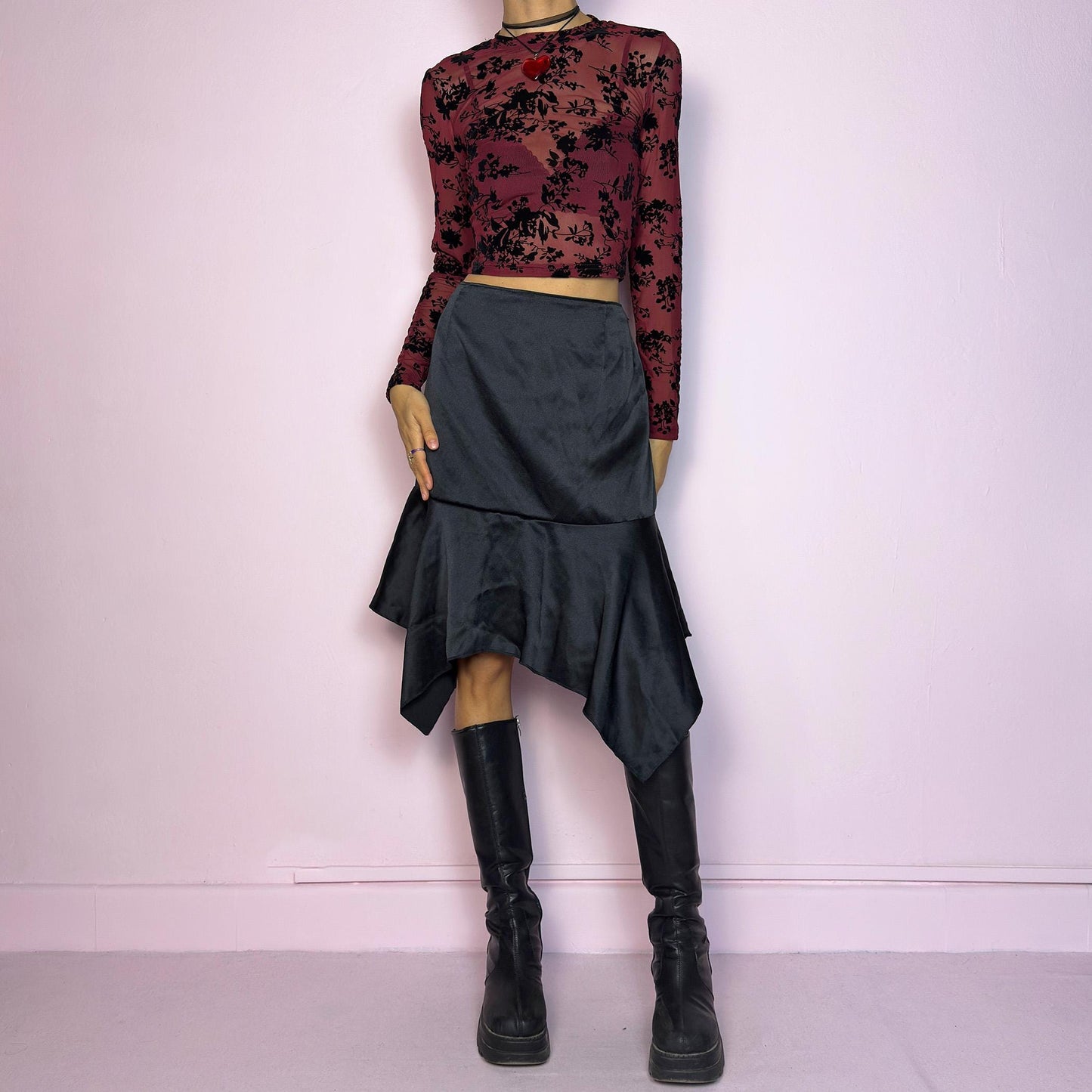 The Y2K Black Satin Asymmetric Skirt is a vintage 2000s stylish piece, featuring a satin-like finish with an asymmetrical handkerchief hemline for a dramatic flair and a size zipper closure. Perfect choice for party nights. Adult World Shop