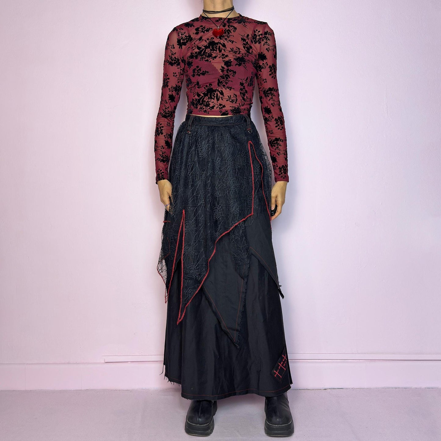 The Black Layered Maxi Skirt is a vintage edgy statement piece crafted by the Japanese punk fashion brand RIGHT? Anarchxism = Kexstation. It features a multi-layered design with mesh web-like overlays, bold red stitching details. Adult World Shop