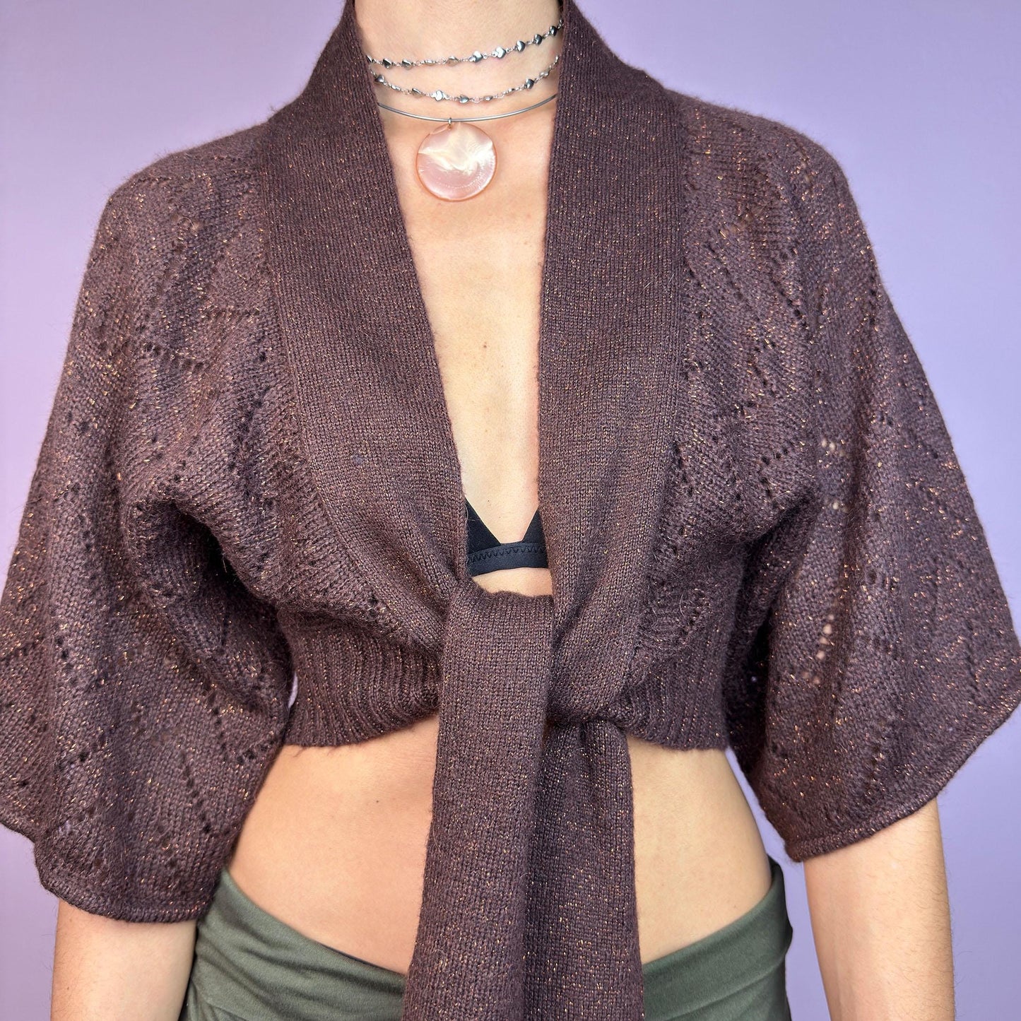 The Y2K Brown Knit Cardigan Bolero is a chic vintage 2000s piece. This cropped bolero features an open-knit design, short sleeves, and a long tie-front closure for an adjustable fit. Its warm brown tone. adult world shop