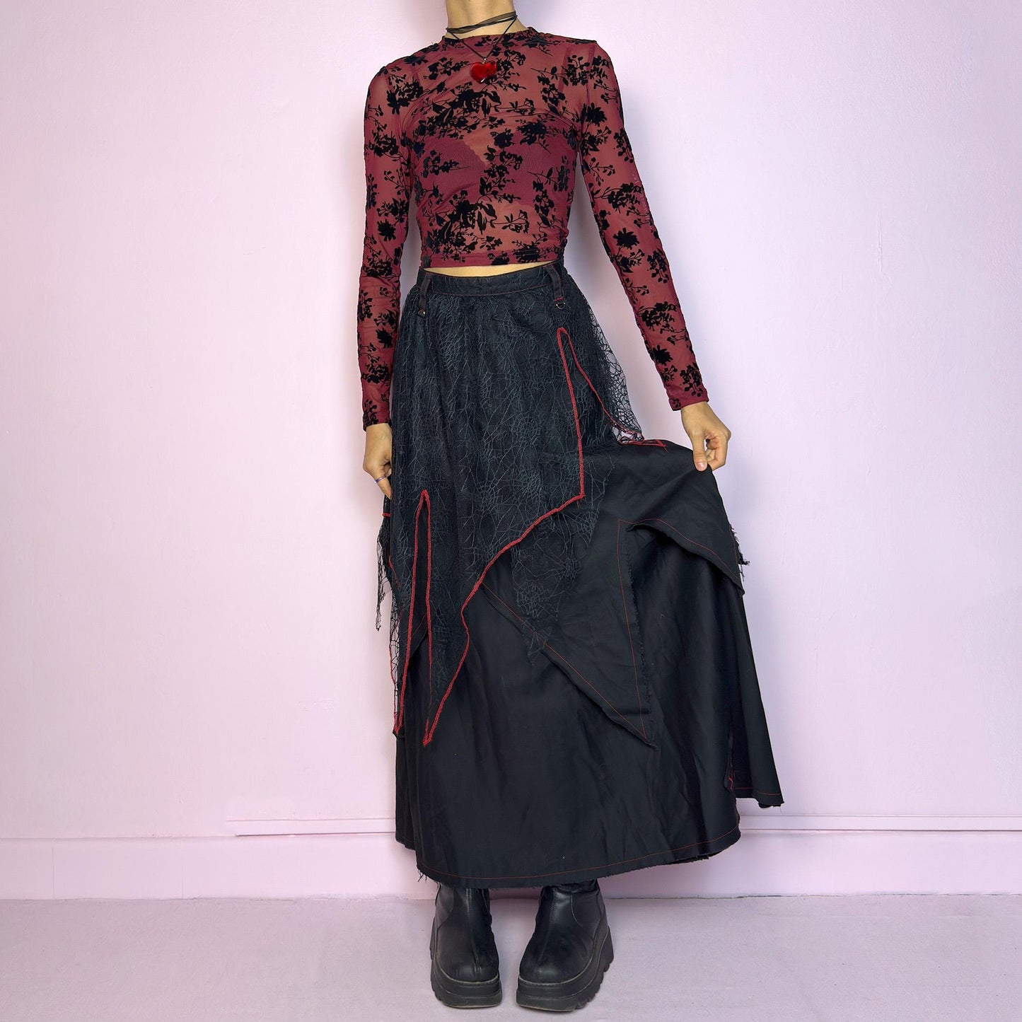 The Black Layered Maxi Skirt is a vintage edgy statement piece crafted by the Japanese punk fashion brand RIGHT? Anarchxism = Kexstation. It features a multi-layered design with mesh web-like overlays, bold red stitching details. Adult World Shop