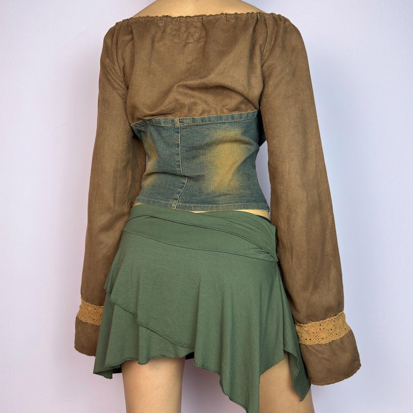 The Y2K Brown Denim Corset Top is a vintage 2000s statement piece blending earthy tones. Crafted with faux suede, this off-the-shoulder top features flared bell long sleeves adorned with crochet lace accents. adult world shop