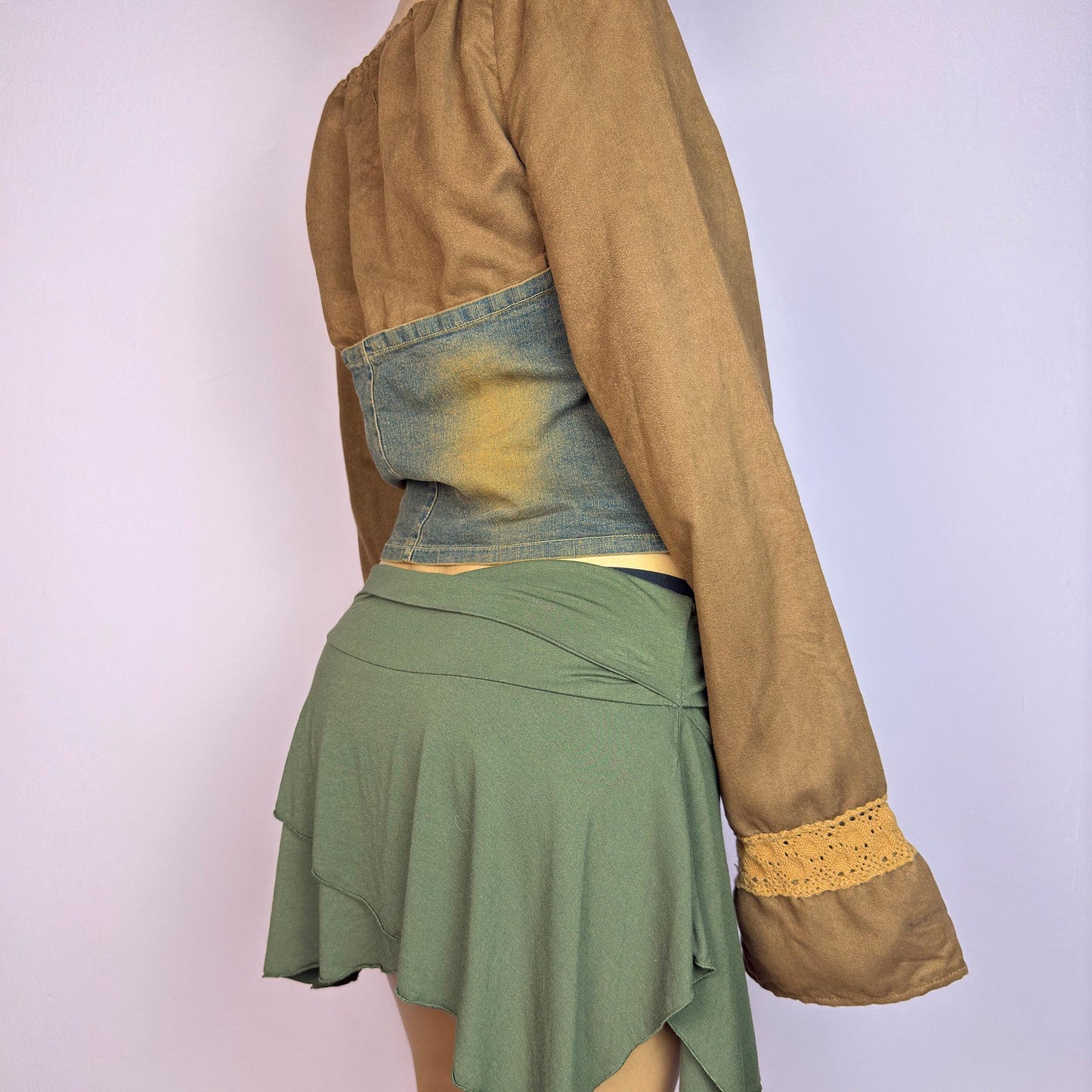 The Y2K Brown Denim Corset Top is a vintage 2000s statement piece blending earthy tones. Crafted with faux suede, this off-the-shoulder top features flared bell long sleeves adorned with crochet lace accents. adult world shop